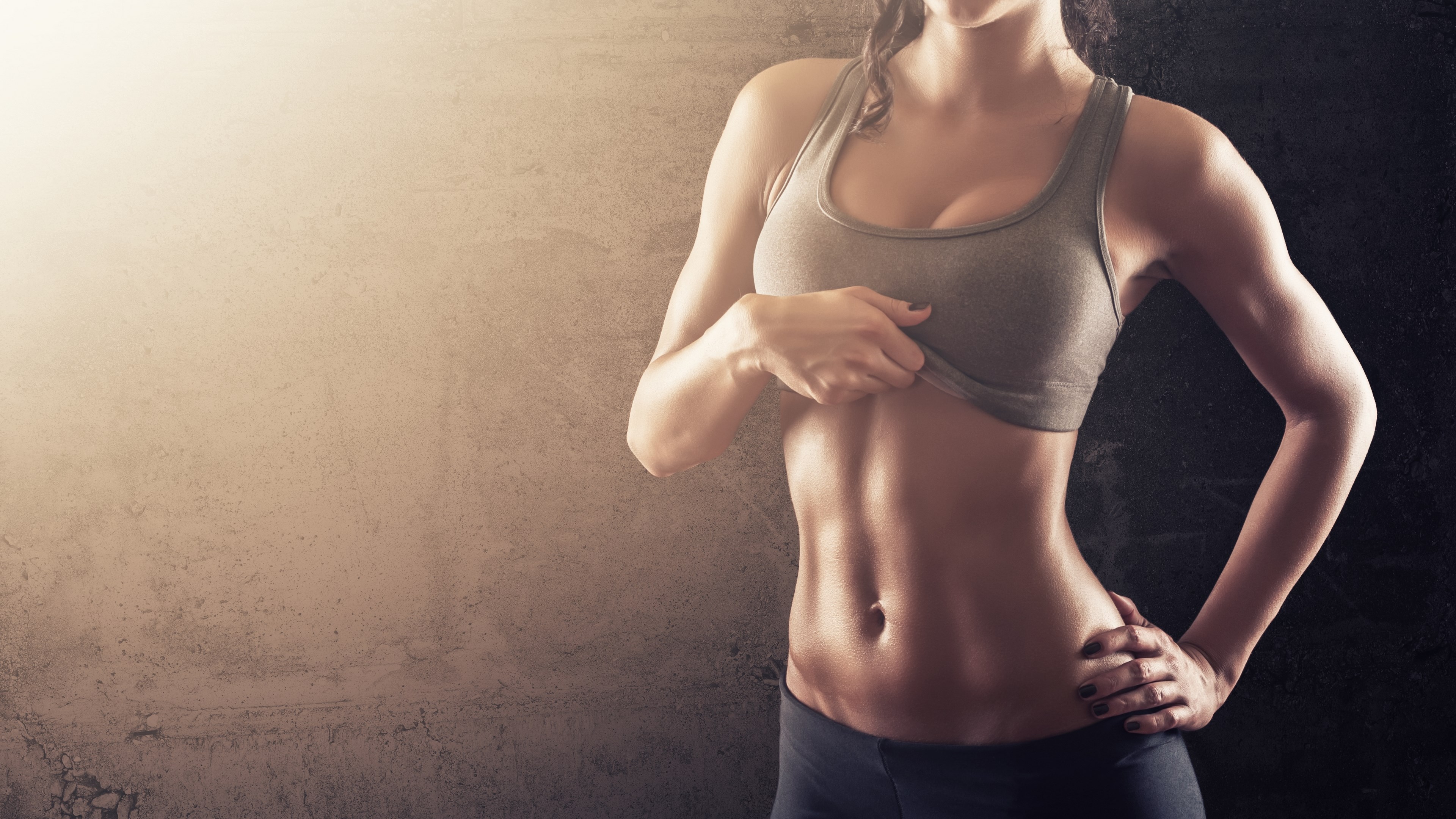 Woman showing toned abs in sports bra HD Wallpaper