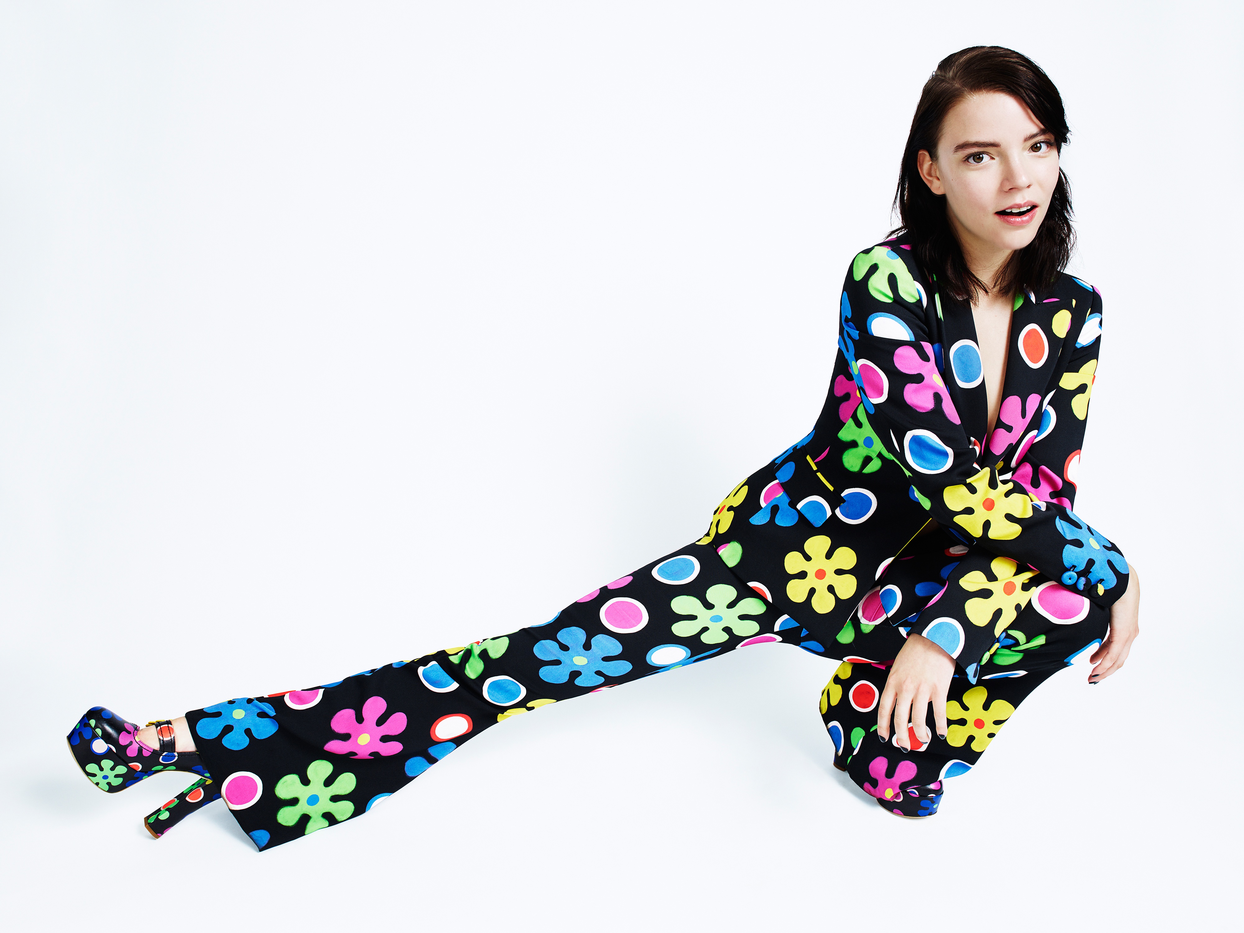 Anya Taylor-Joy in a colorful floral suit HD Wallpaper