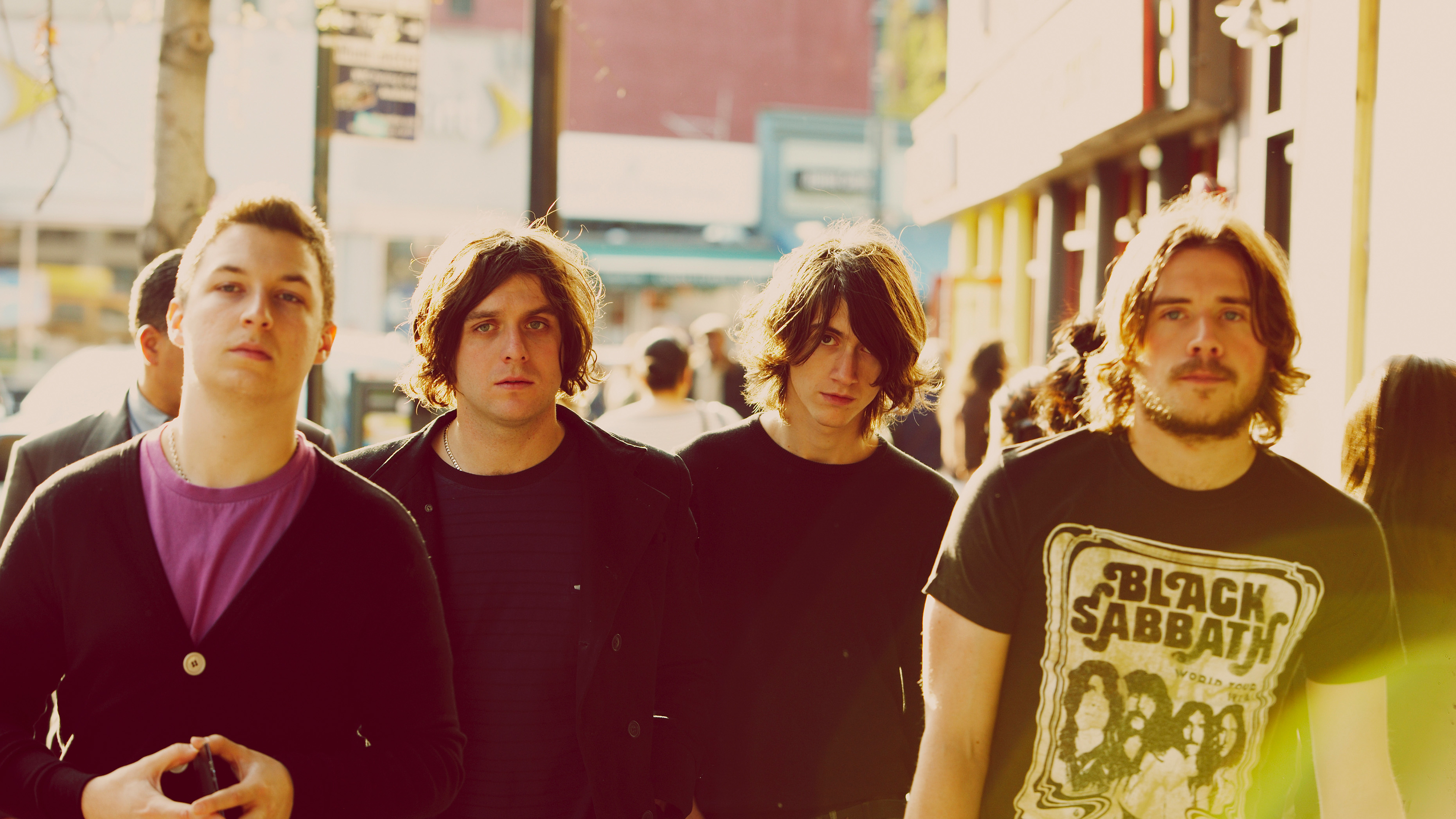 Arctic Monkeys band members walking on a street HD Wallpaper