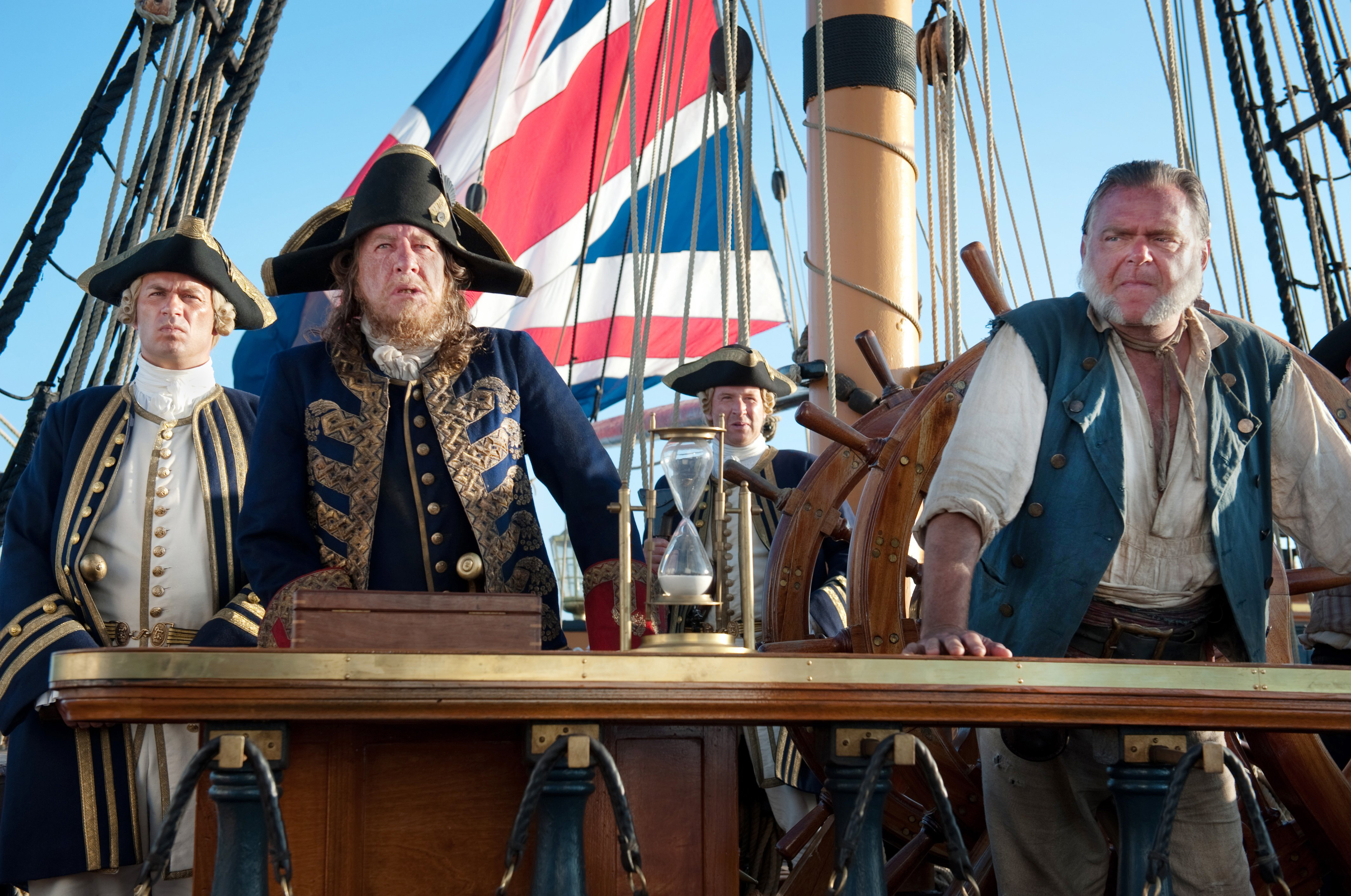 Four men on a ship with a British flag HD Wallpaper