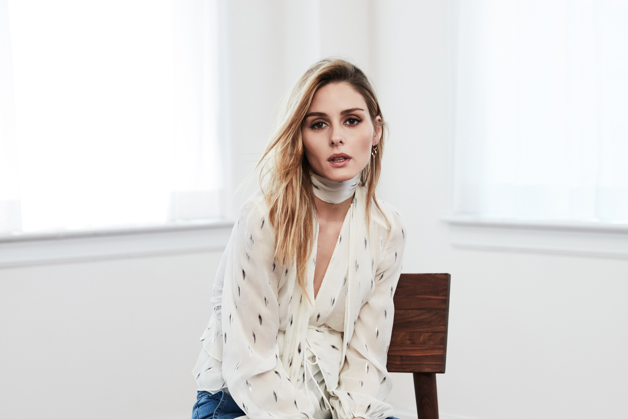 Olivia Palermo sitting on a chair HD Wallpaper