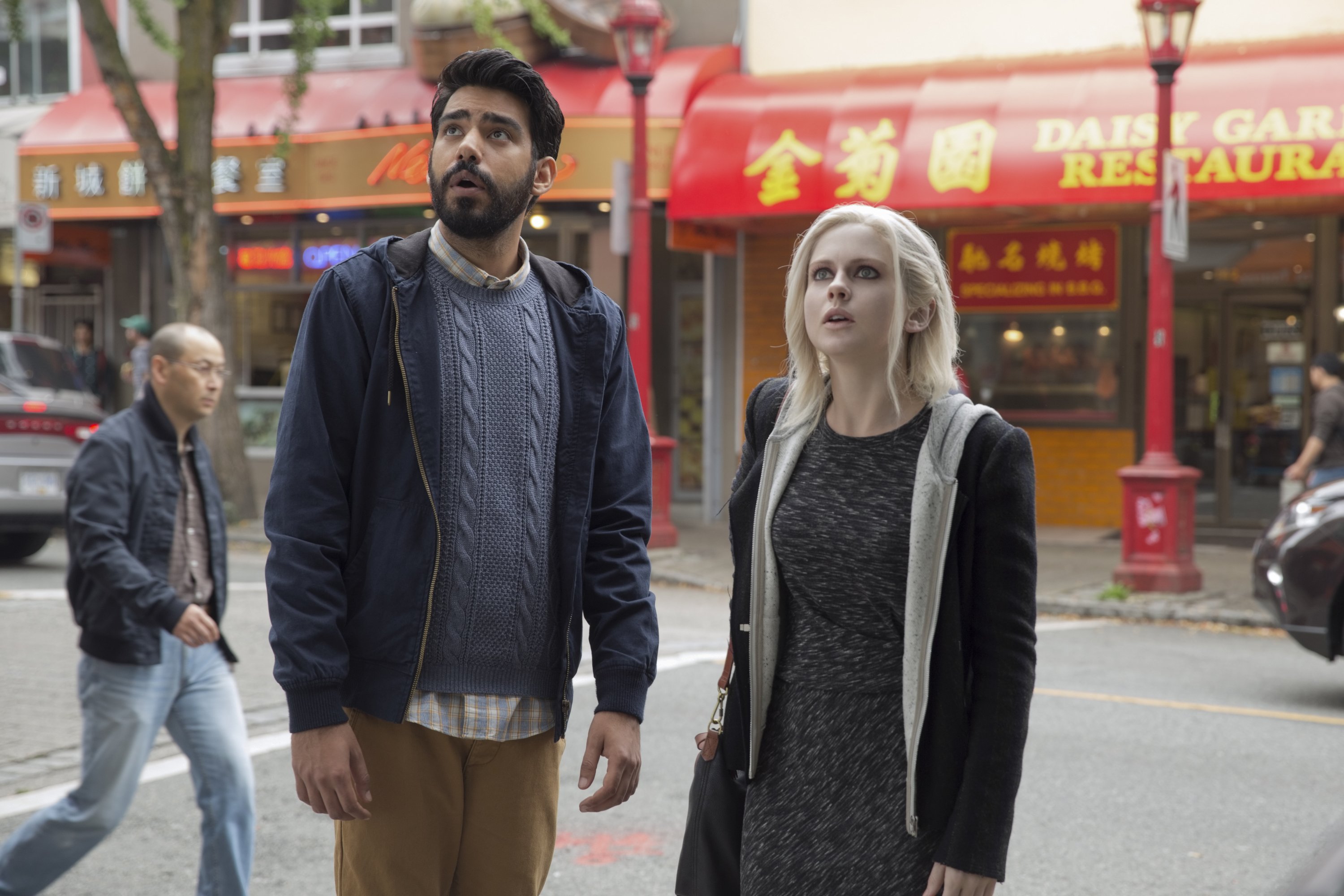 Rahul Kohli and Liv Moore in a city street HD Wallpaper