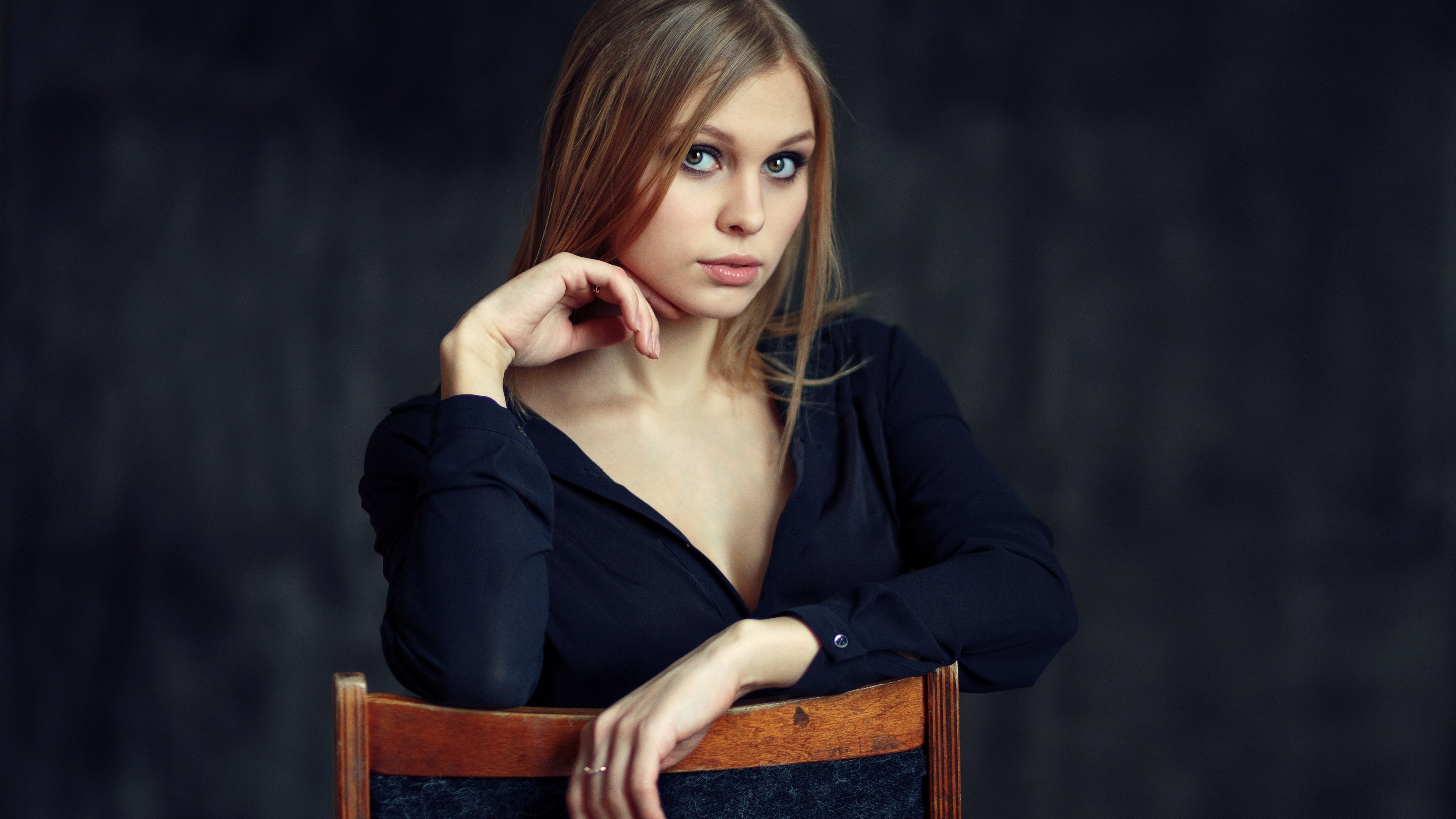 Woman in black shirt sitting on a chair HD Wallpaper