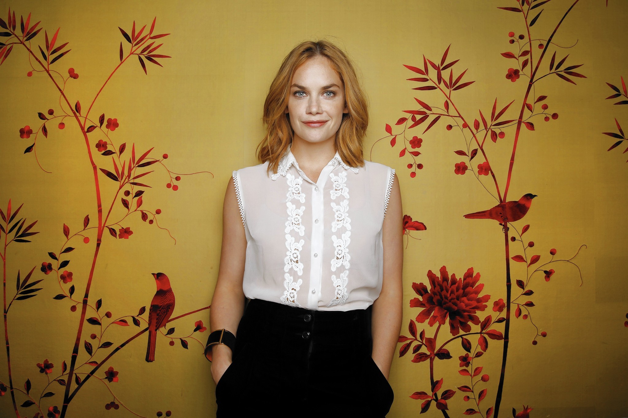 Ruth Wilson posing in front of a floral wallpaper HD Wallpaper