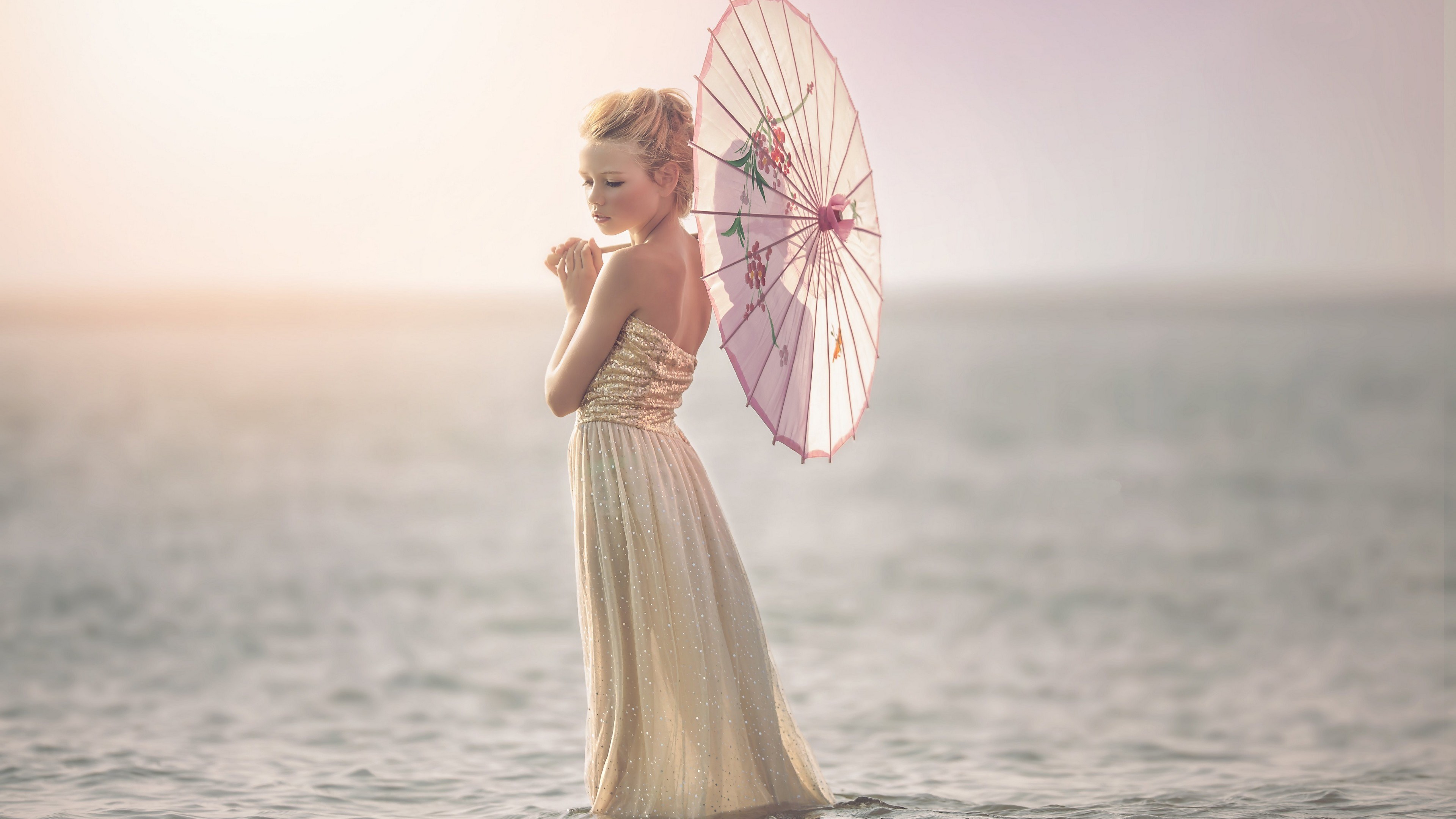 Girl in a dress holding a parasol in the water HD Wallpaper
