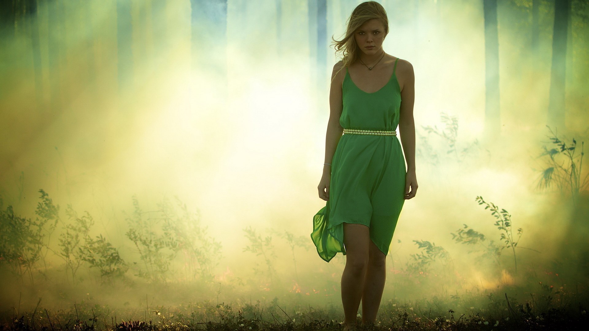 Woman in green dress in smoky forest HD Wallpaper