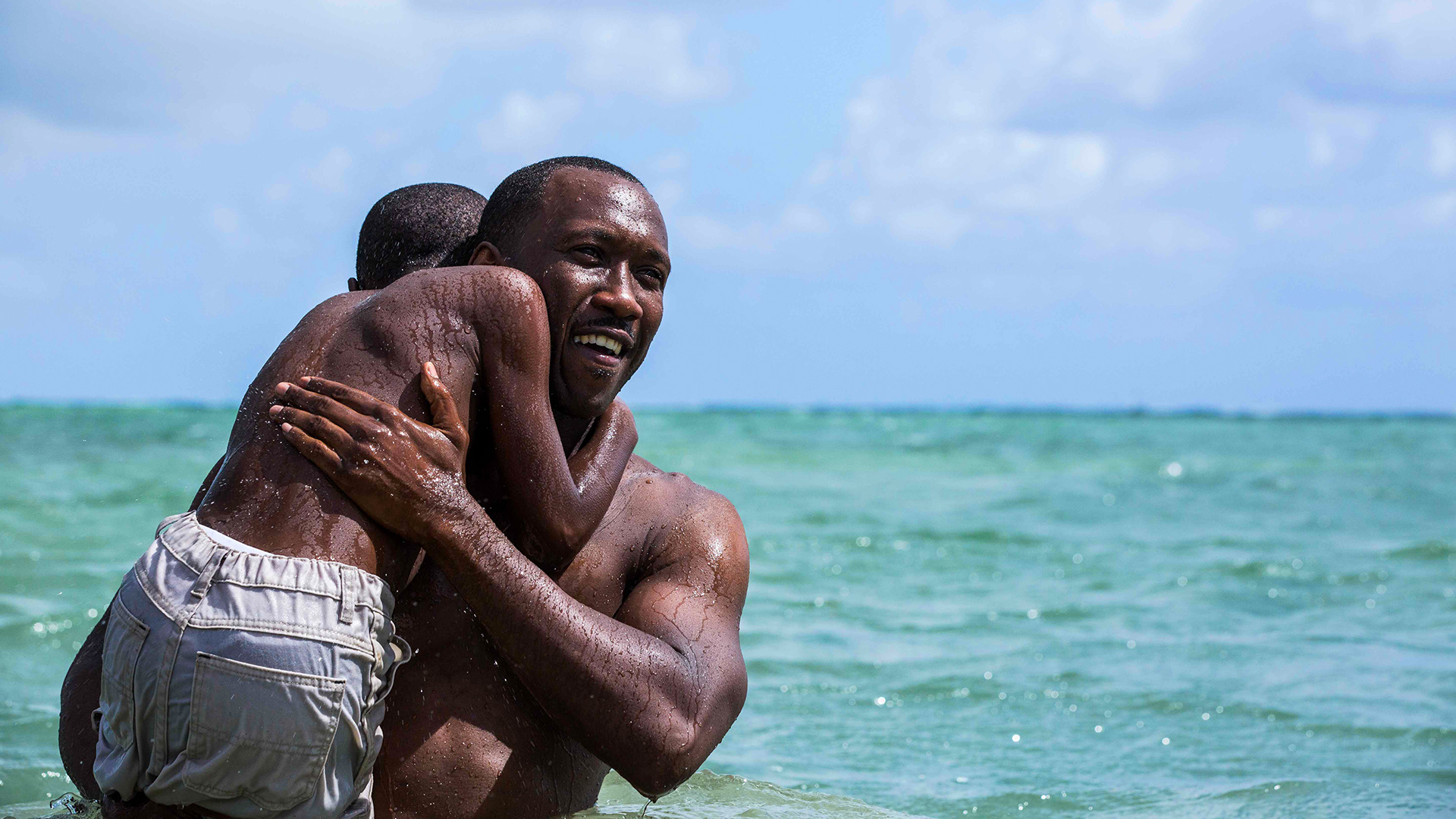 Mahershala Ali and child in the ocean HD Wallpaper