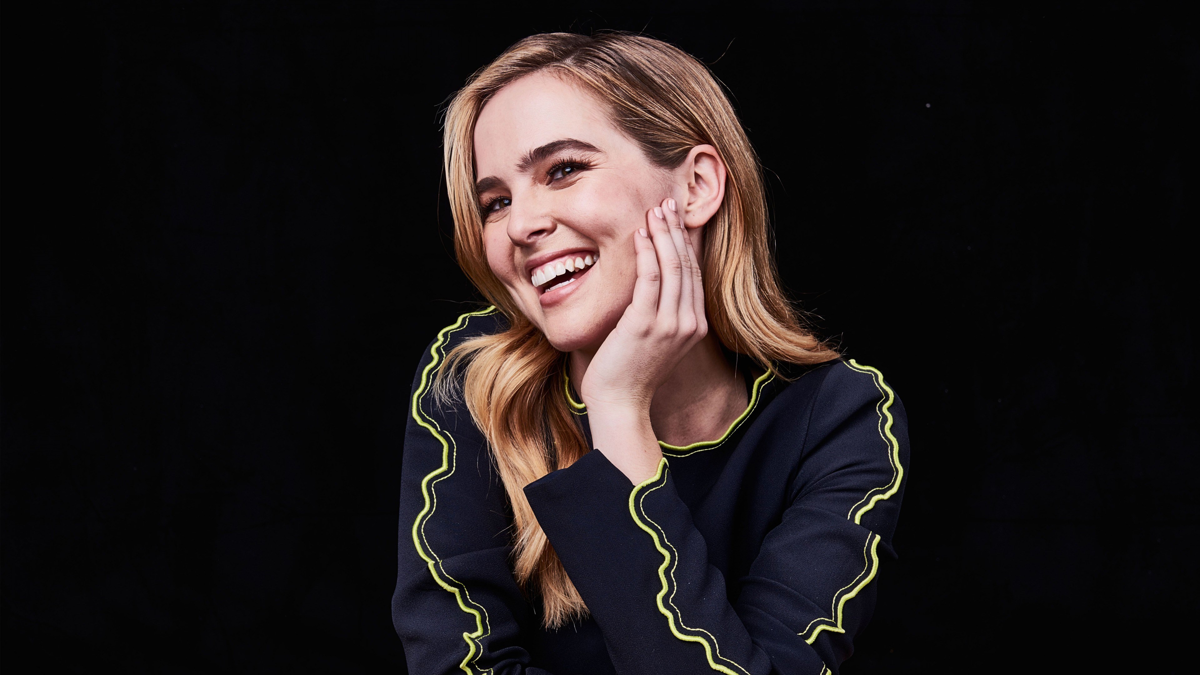 Zoey Deutch smiling with hand on cheek HD Wallpaper