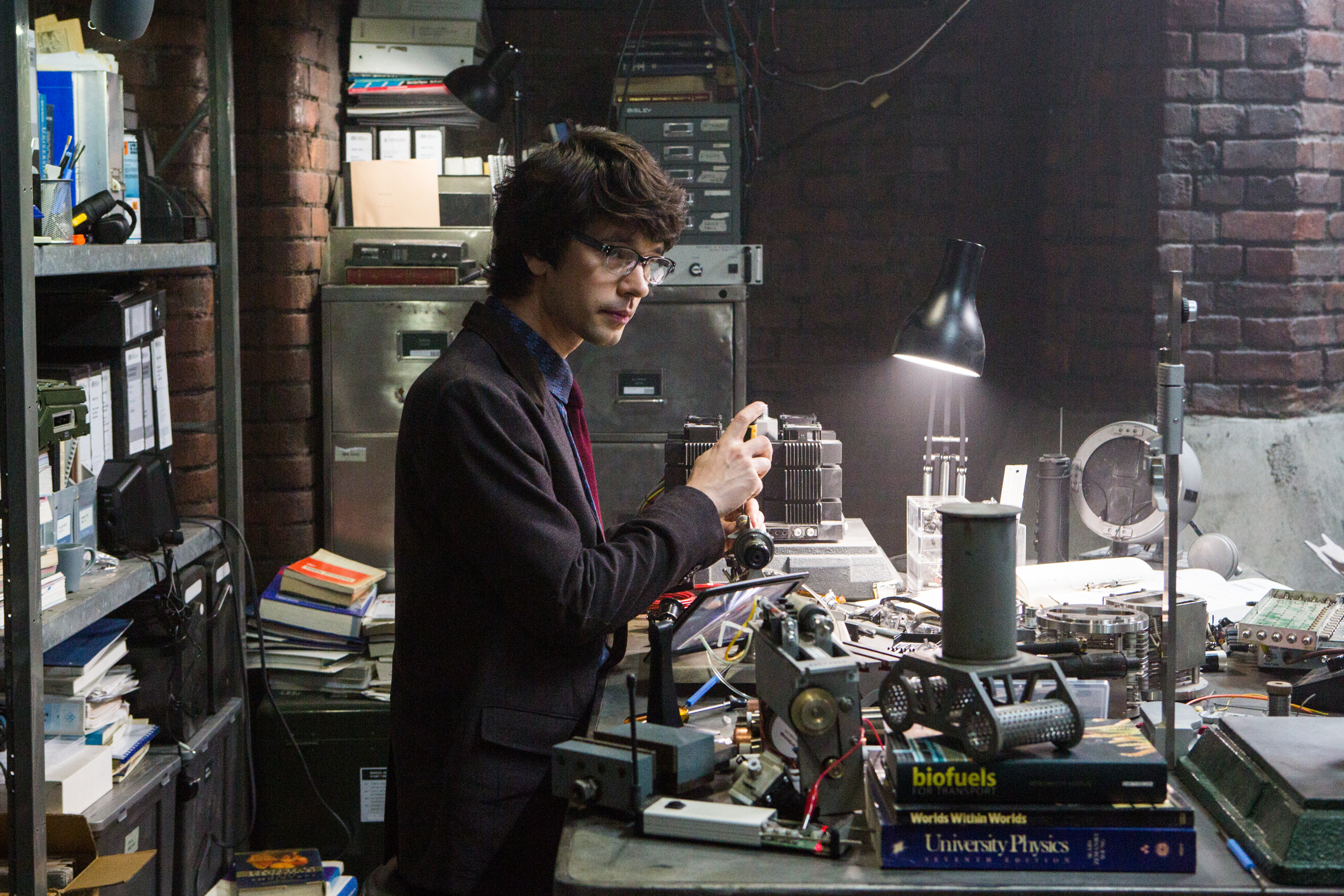 Ben Whishaw in a cluttered laboratory HD Wallpaper