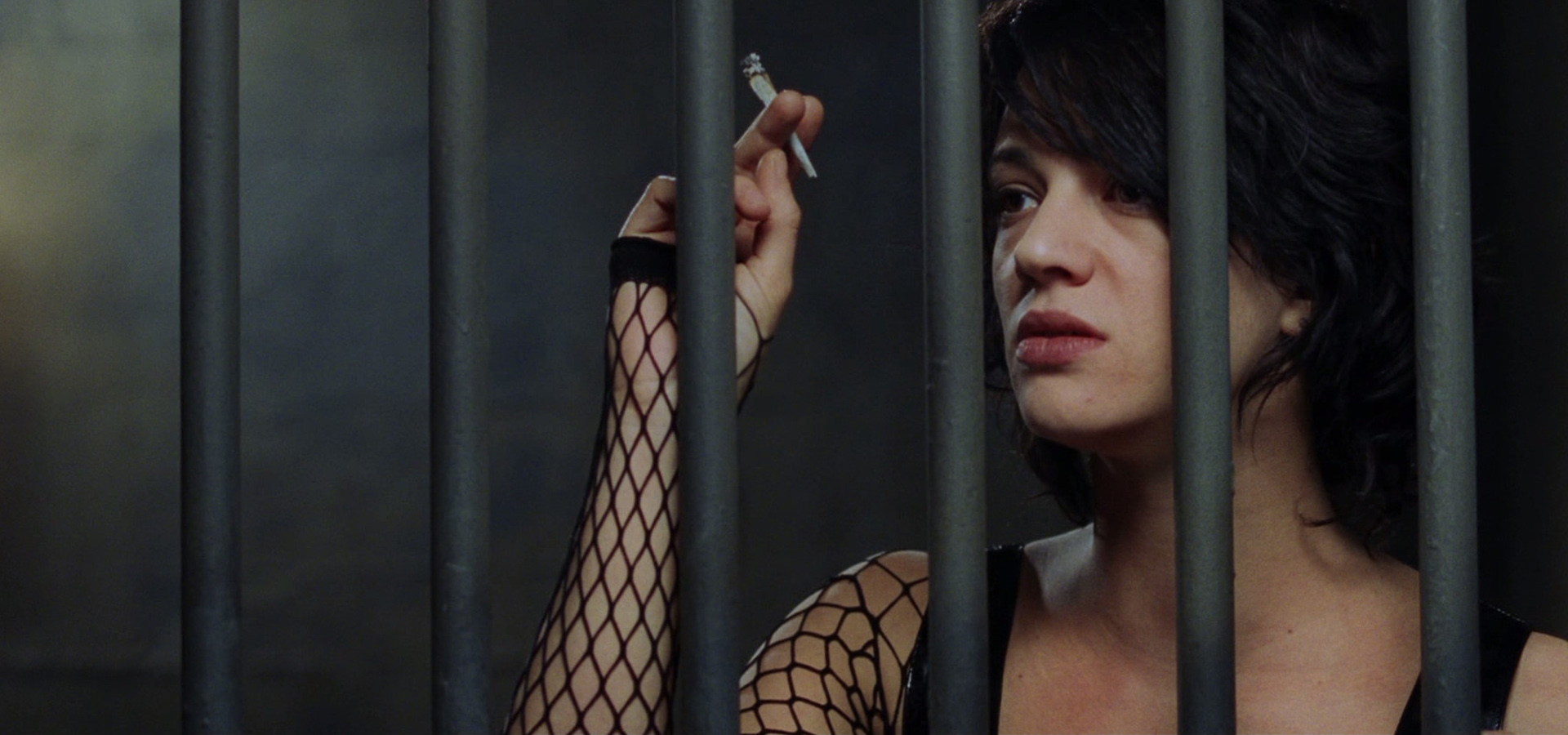Asia Argento smoking behind bars HD Wallpaper