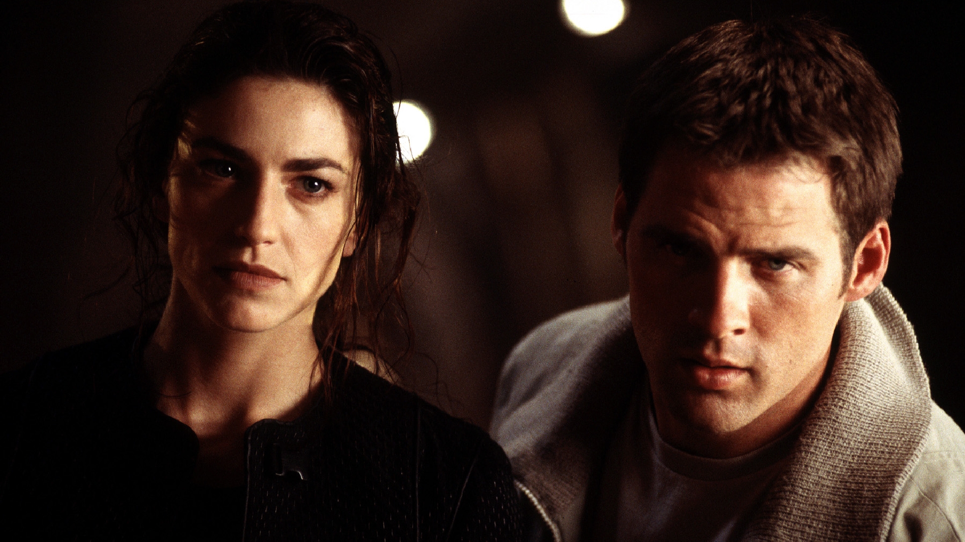 Claudia Black and man in dark setting HD Wallpaper