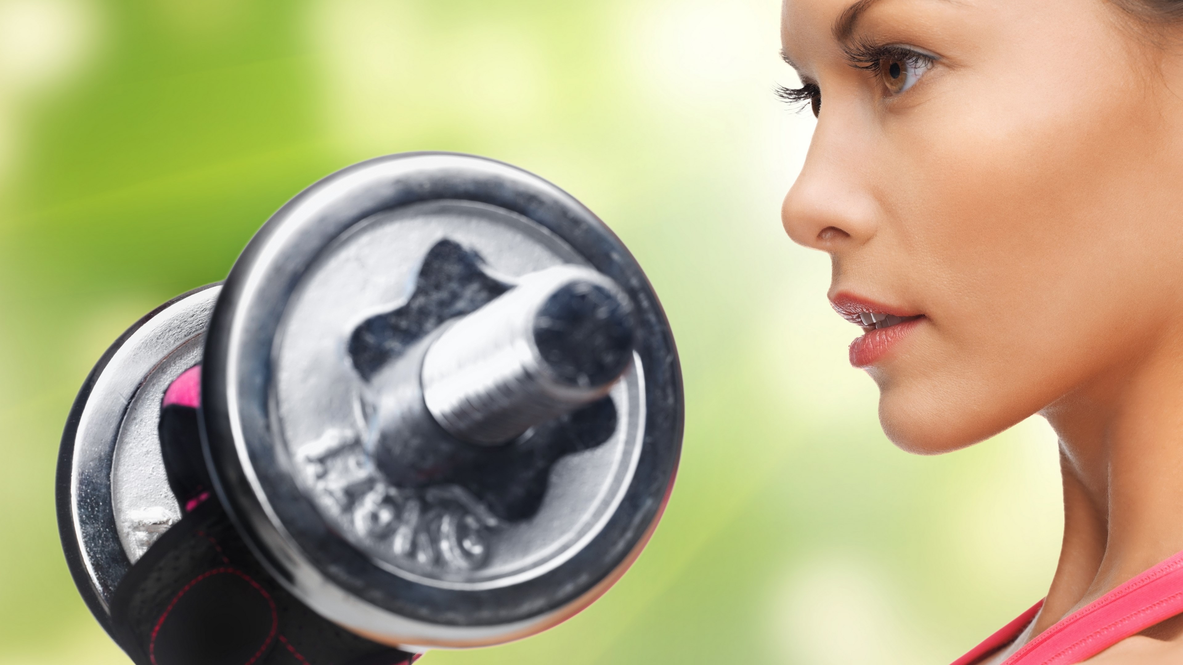 Woman lifting a dumbbell HD Wallpaper