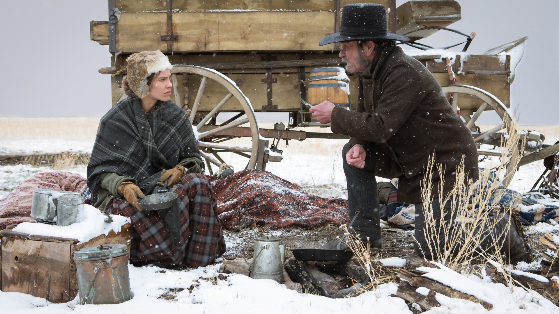Hilary Swank in a snowy landscape with a wagon HD Wallpaper