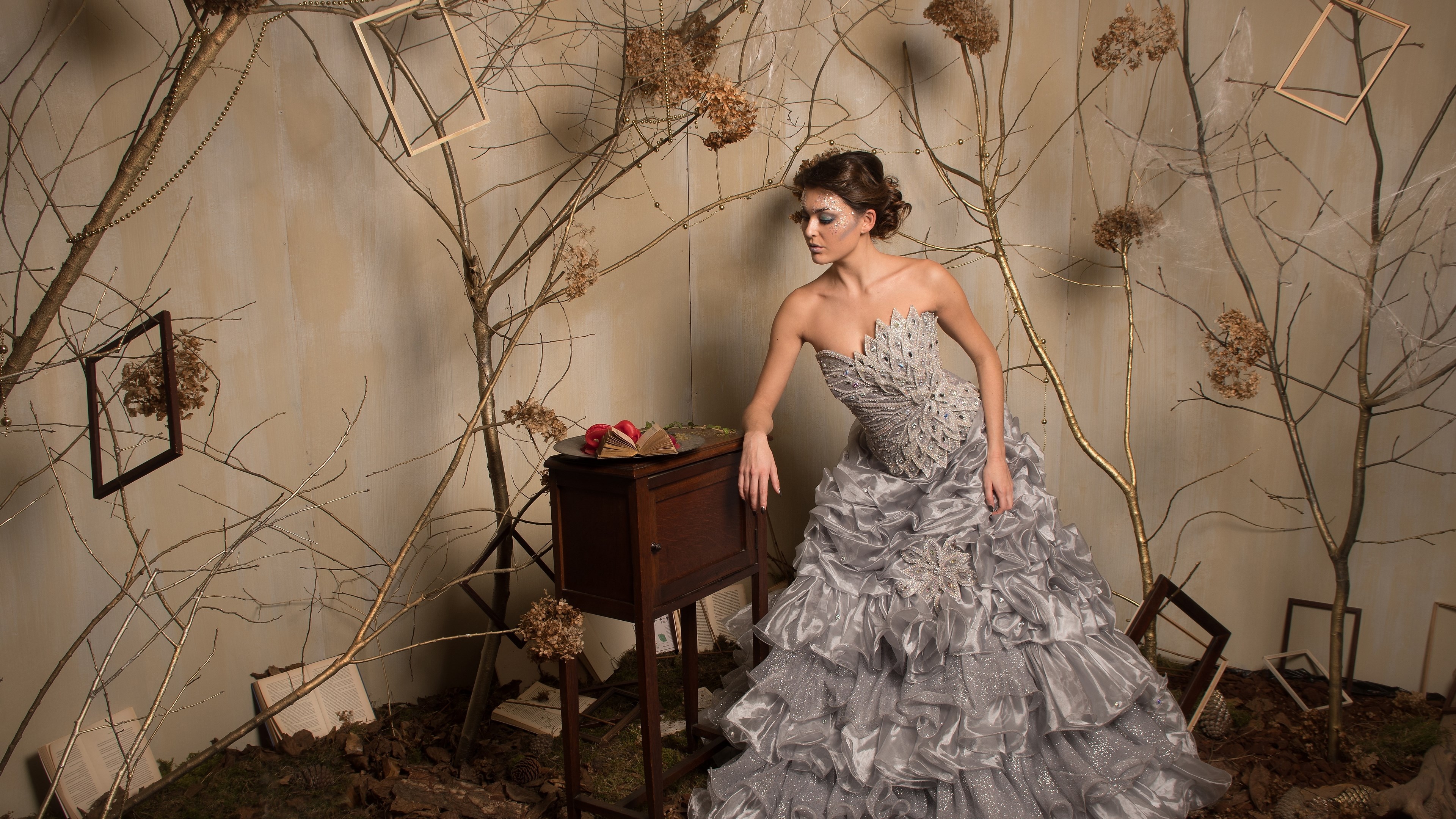 Woman in a silver dress in a forest setting HD Wallpaper