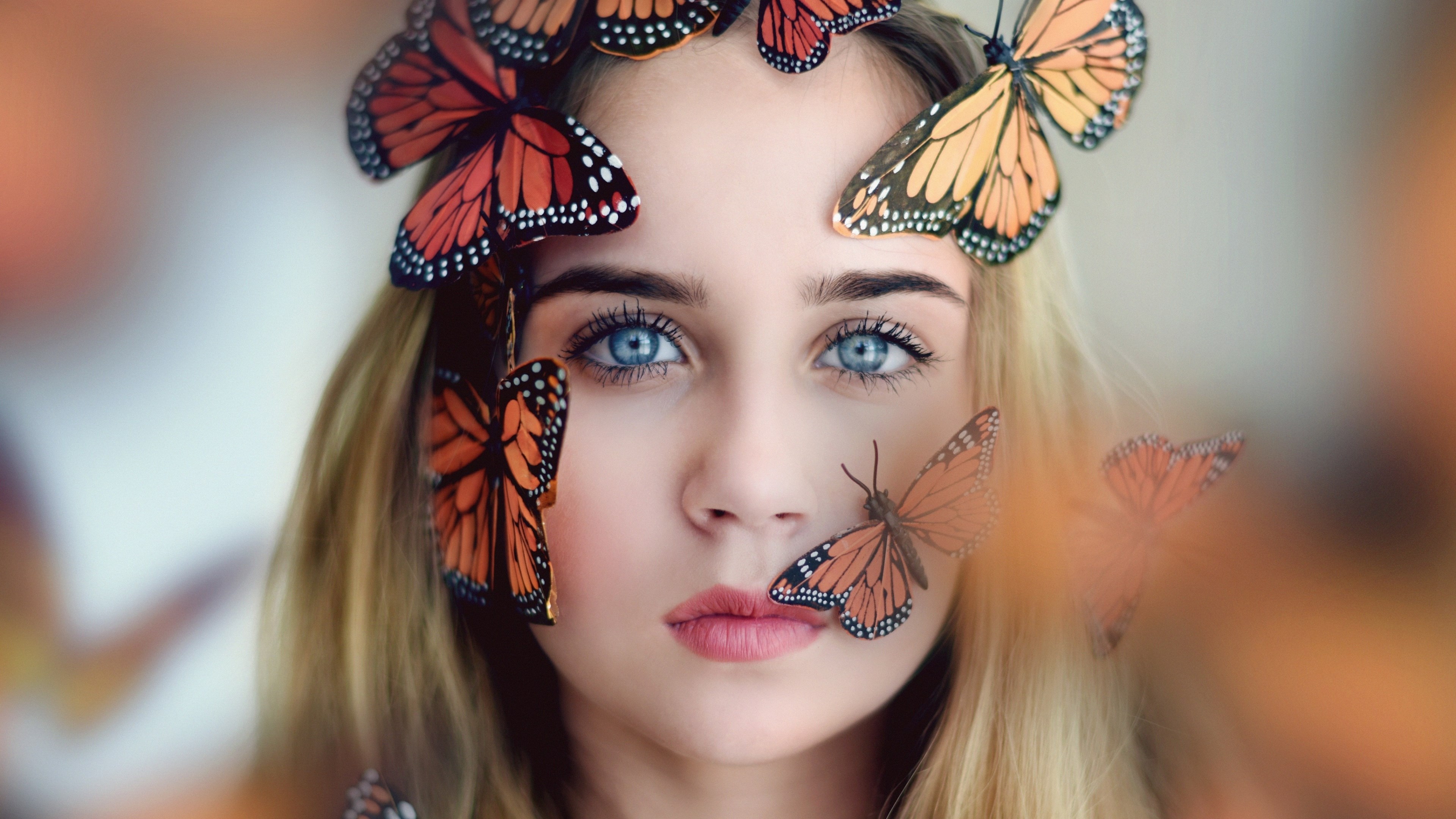 Woman with butterflies on her face HD Wallpaper