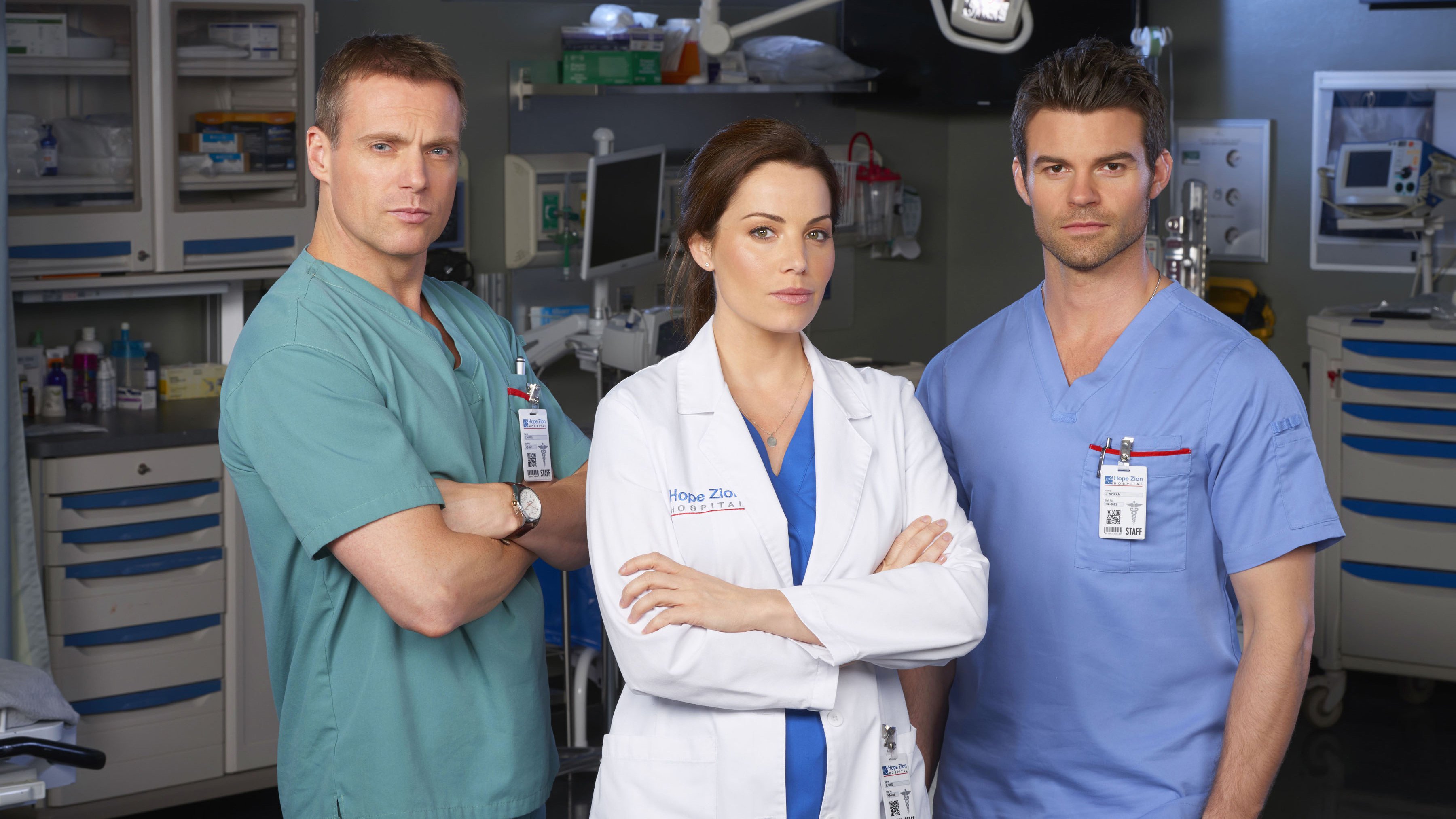 Michael Shanks, Erica Durance, and Benjamin Hollingsworth in hospital HD Wallpaper