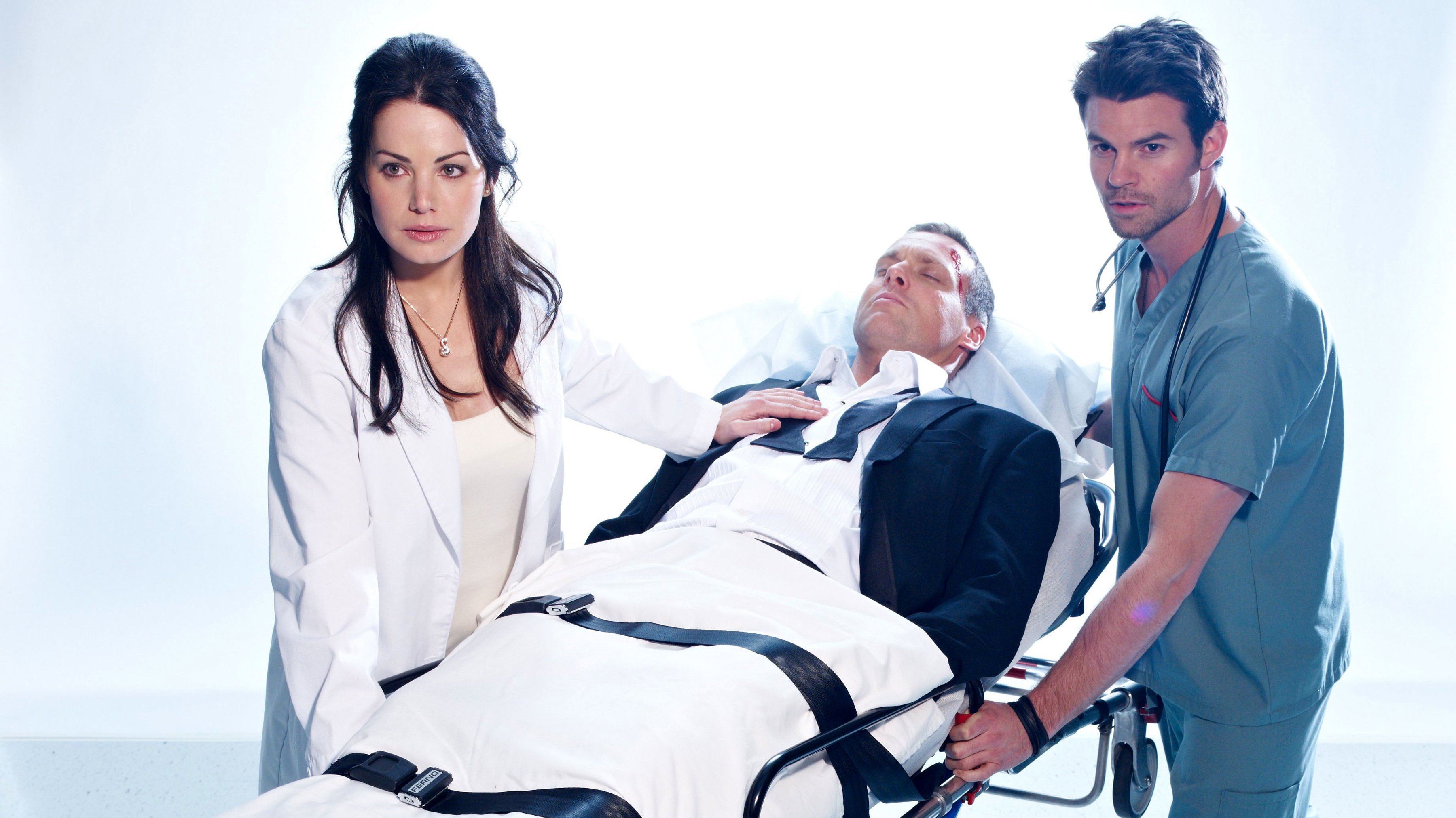 Michael Shanks in Stretcher with Doctors HD Wallpaper