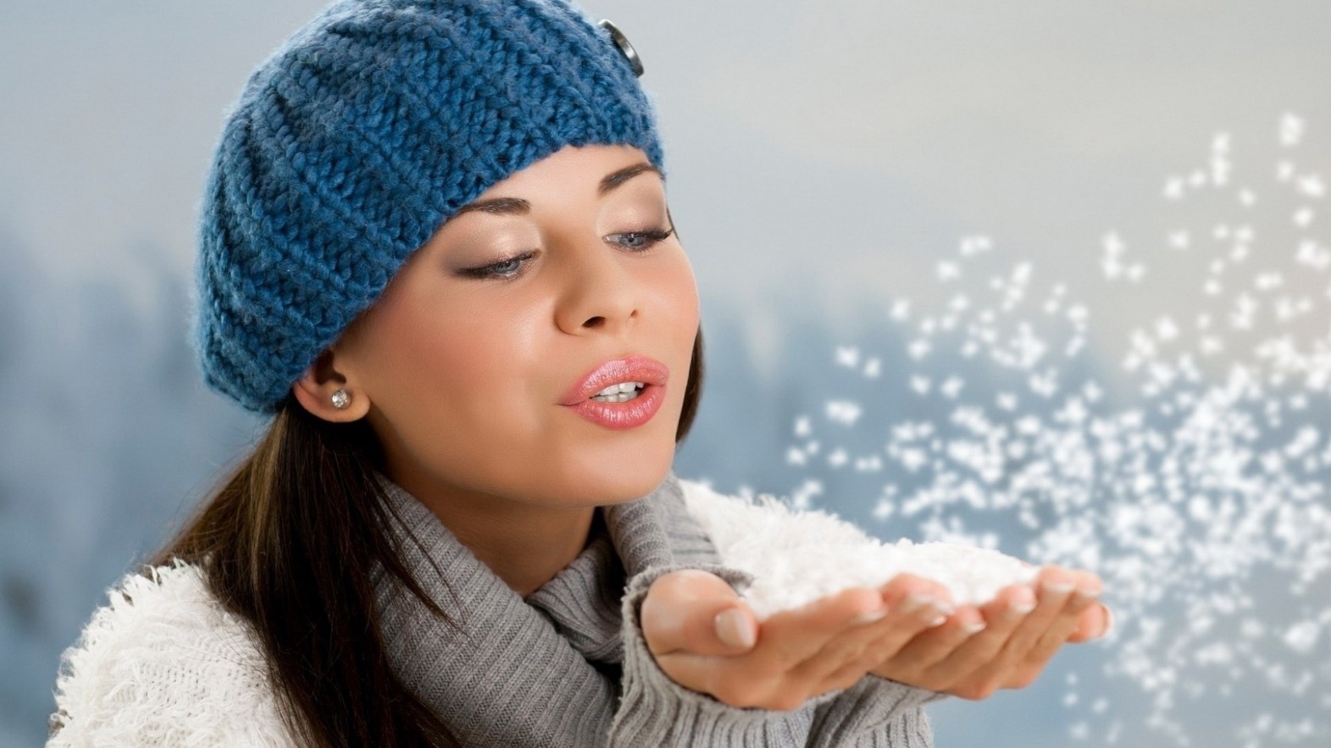 Woman in blue hat blowing snow HD Wallpaper