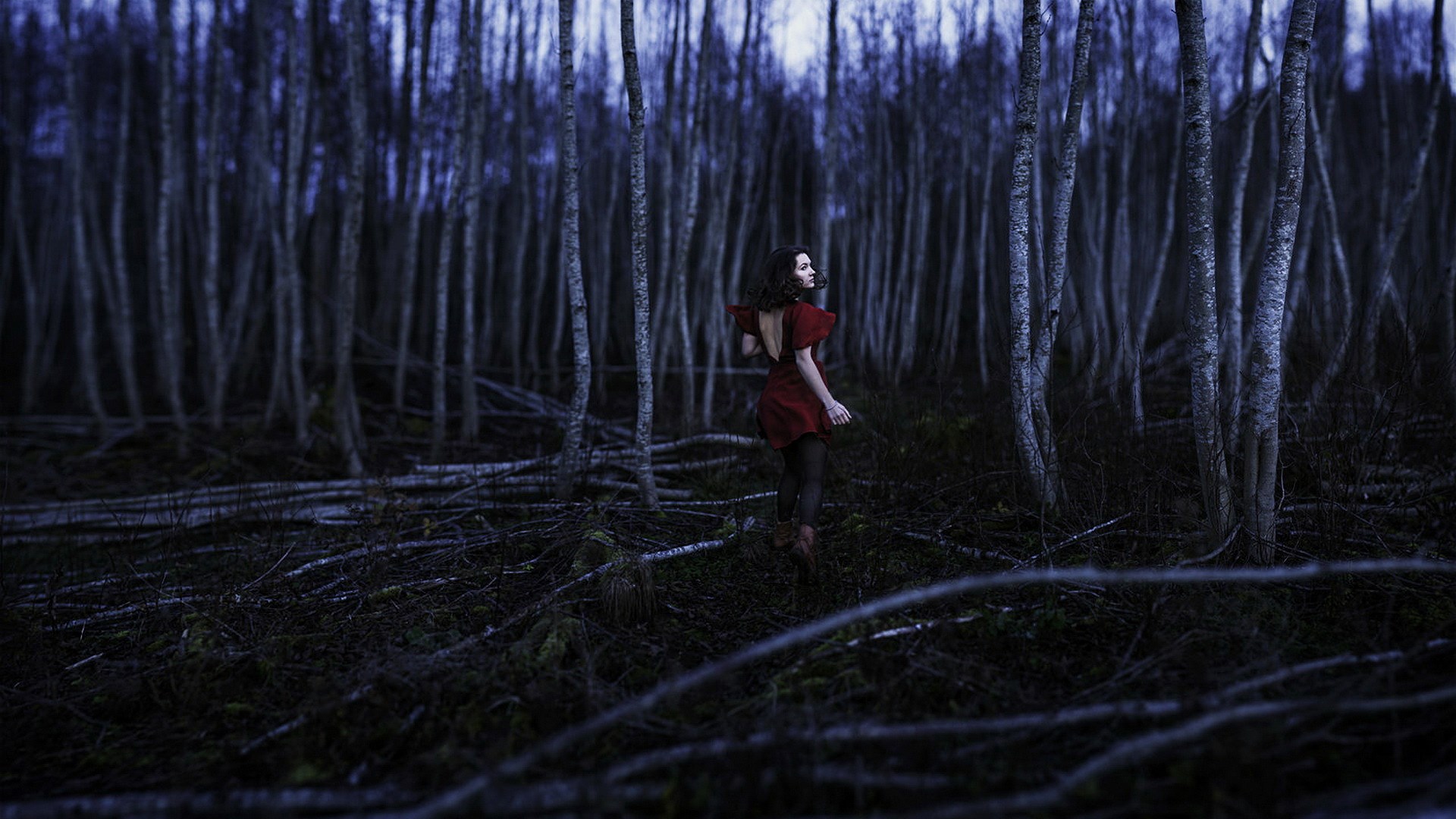 Woman in red dress in dark forest HD Wallpaper