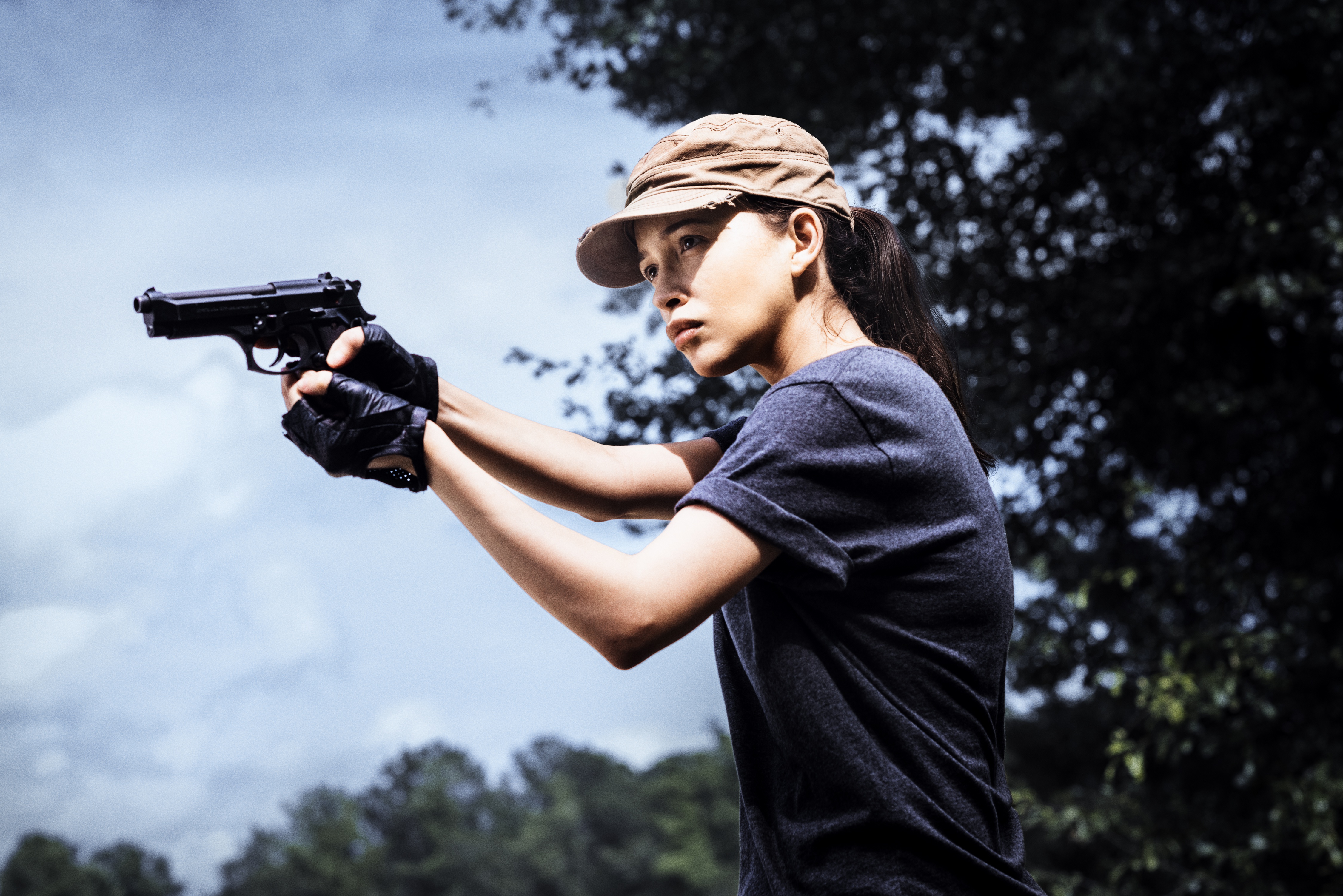 Christian Serratos holding a handgun HD Wallpaper