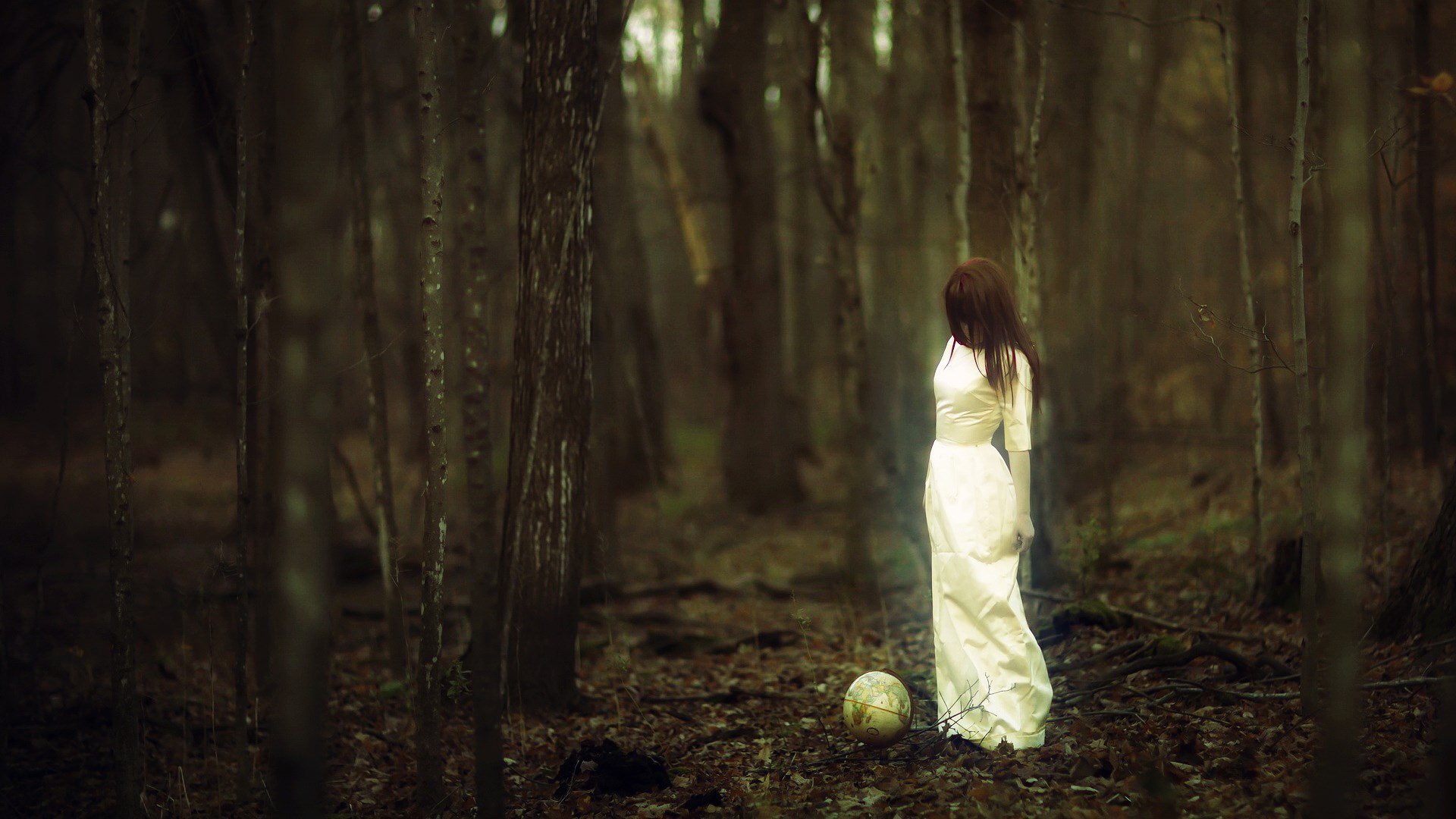 Woman in white dress with globe in forest HD Wallpaper