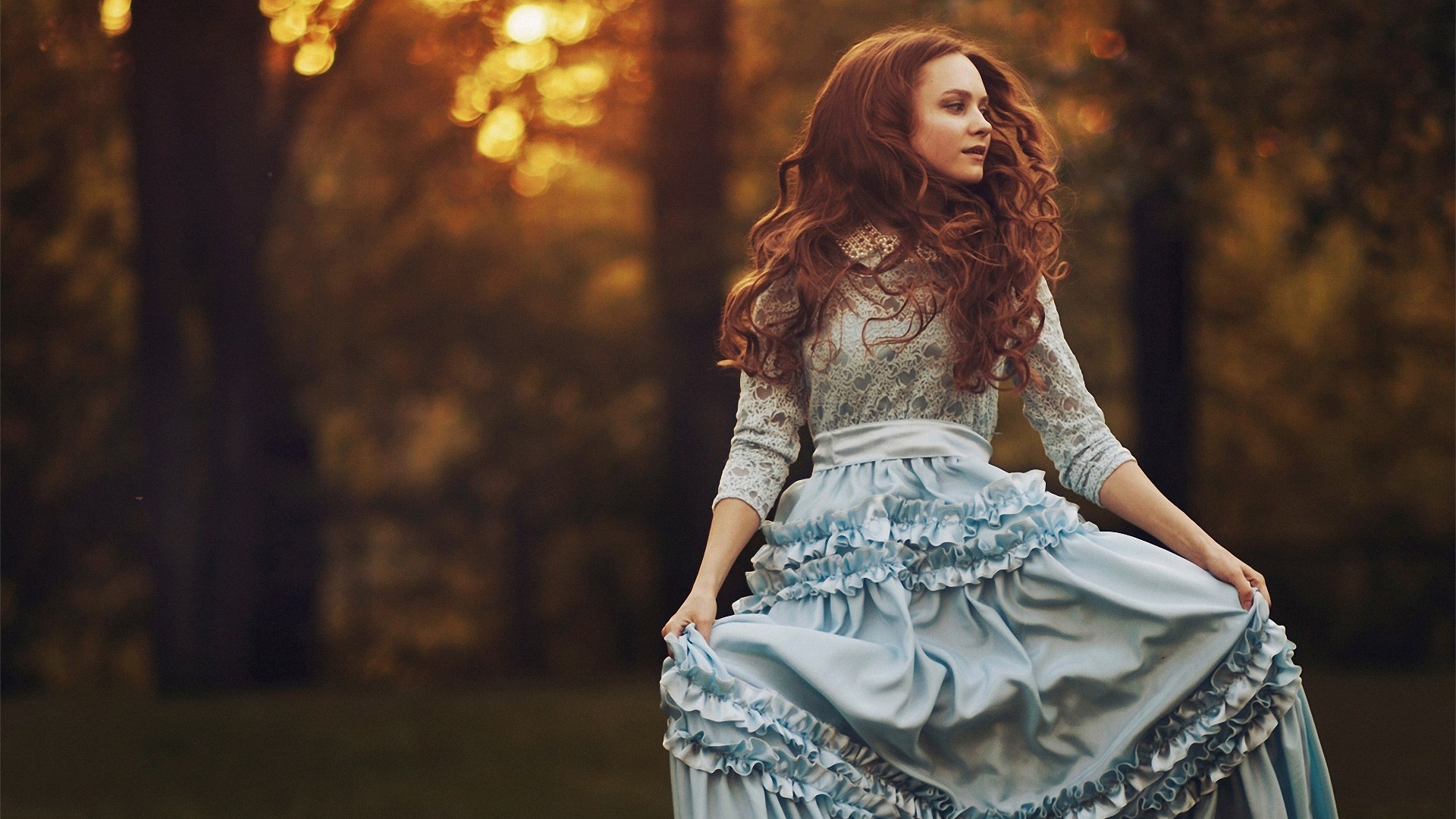 Woman in a blue ruffled dress in a park HD Wallpaper