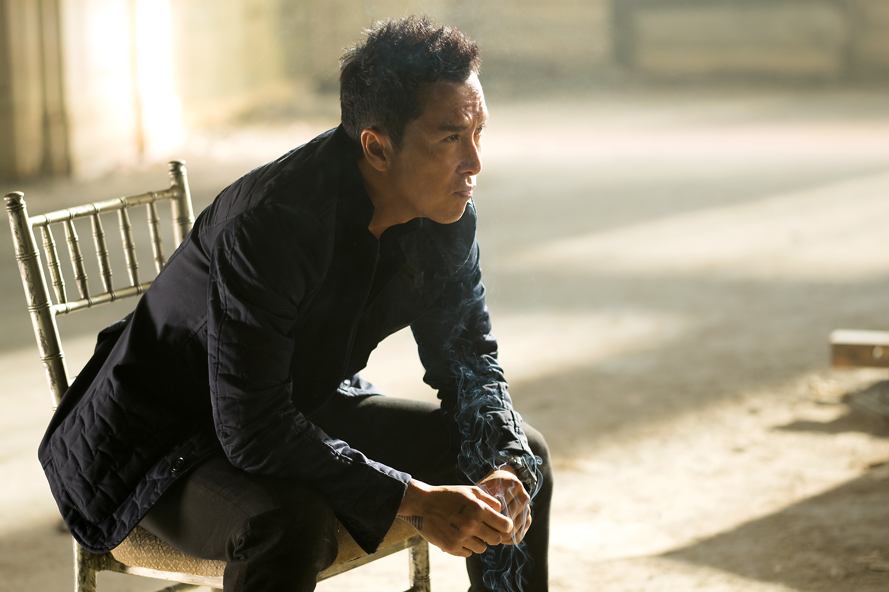 Donnie Yen sitting on a chair HD Wallpaper