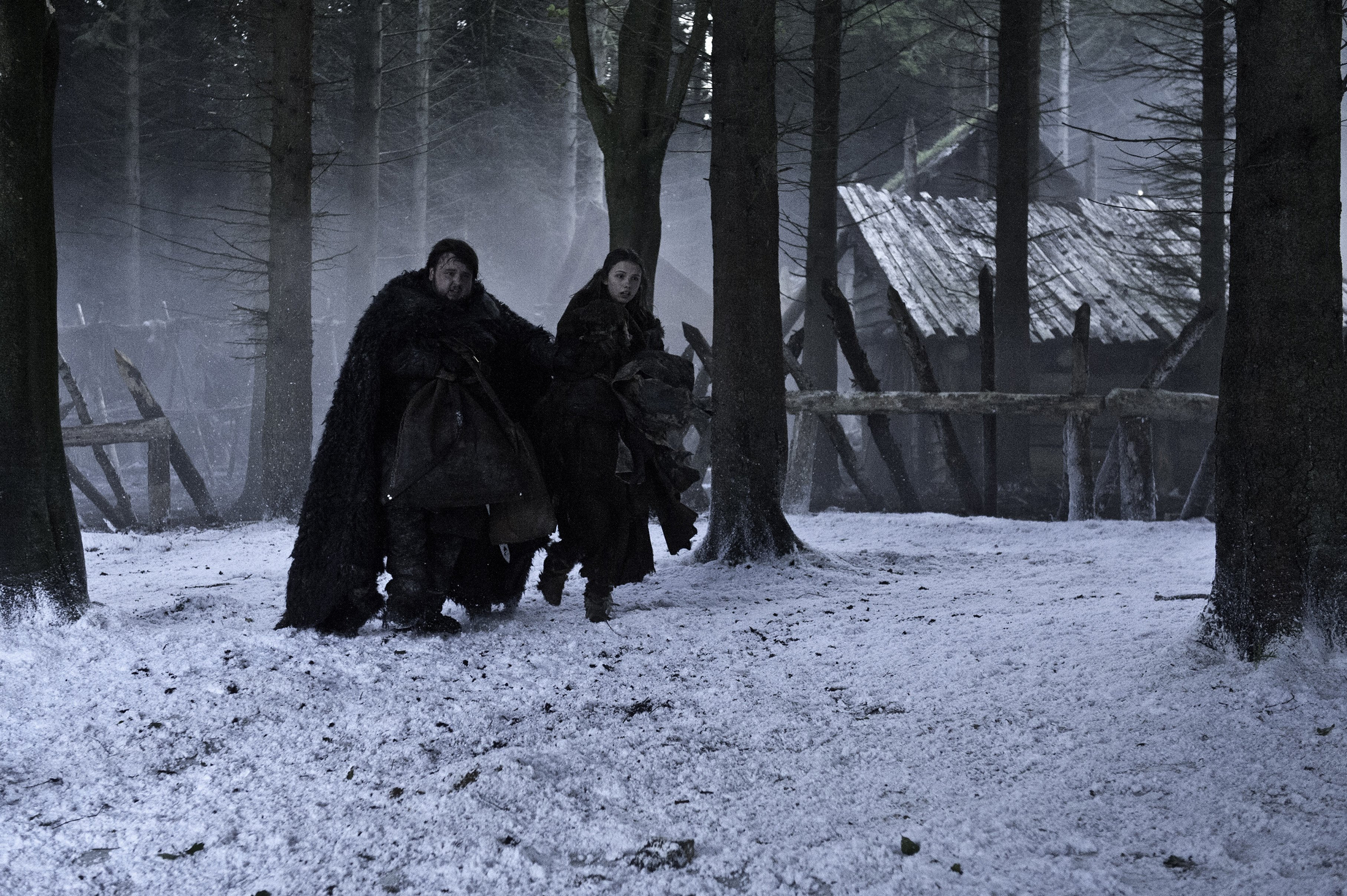 Jon Snow and Arya Stark in a snowy forest HD Wallpaper