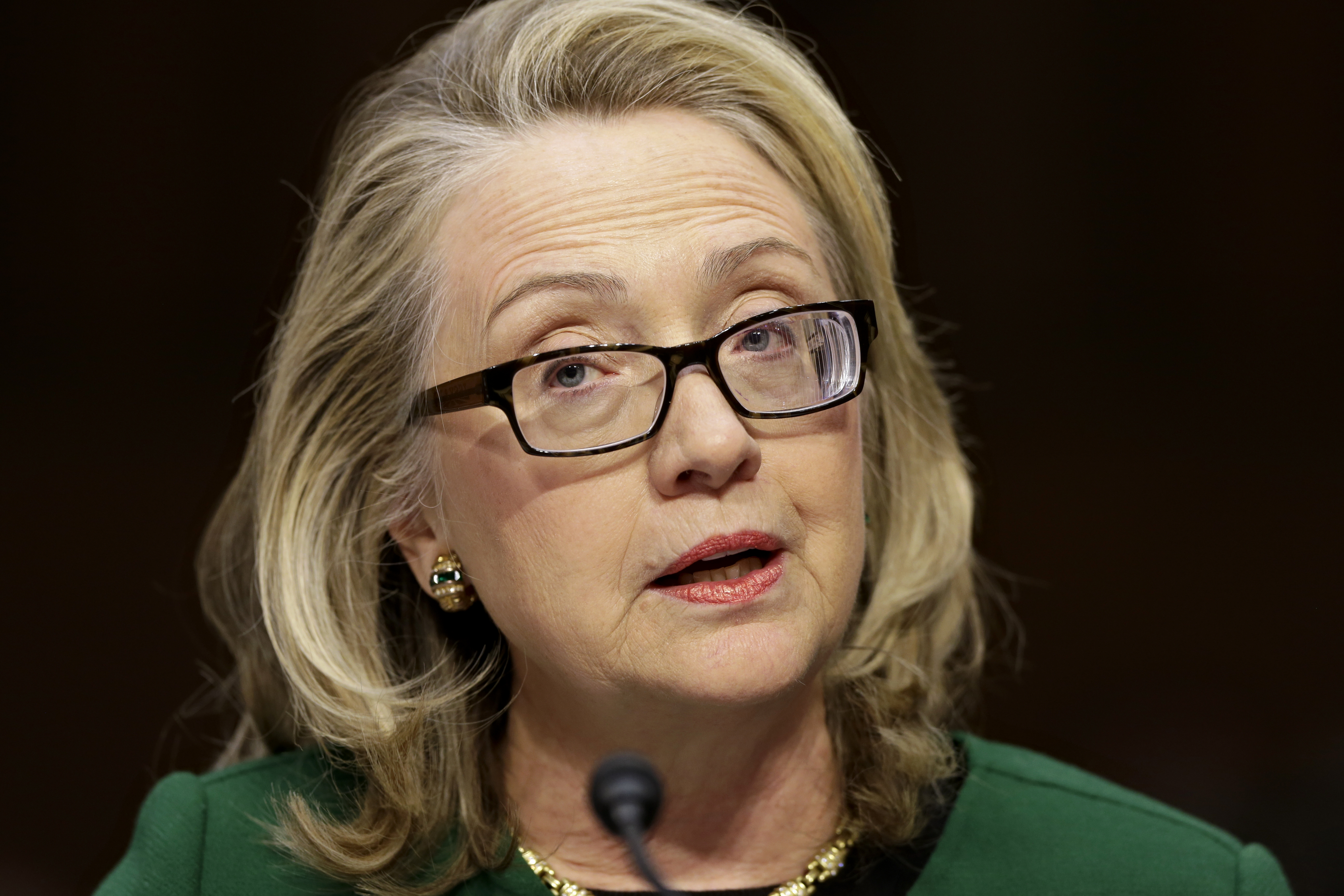 Hillary Clinton speaking at a podium HD Wallpaper