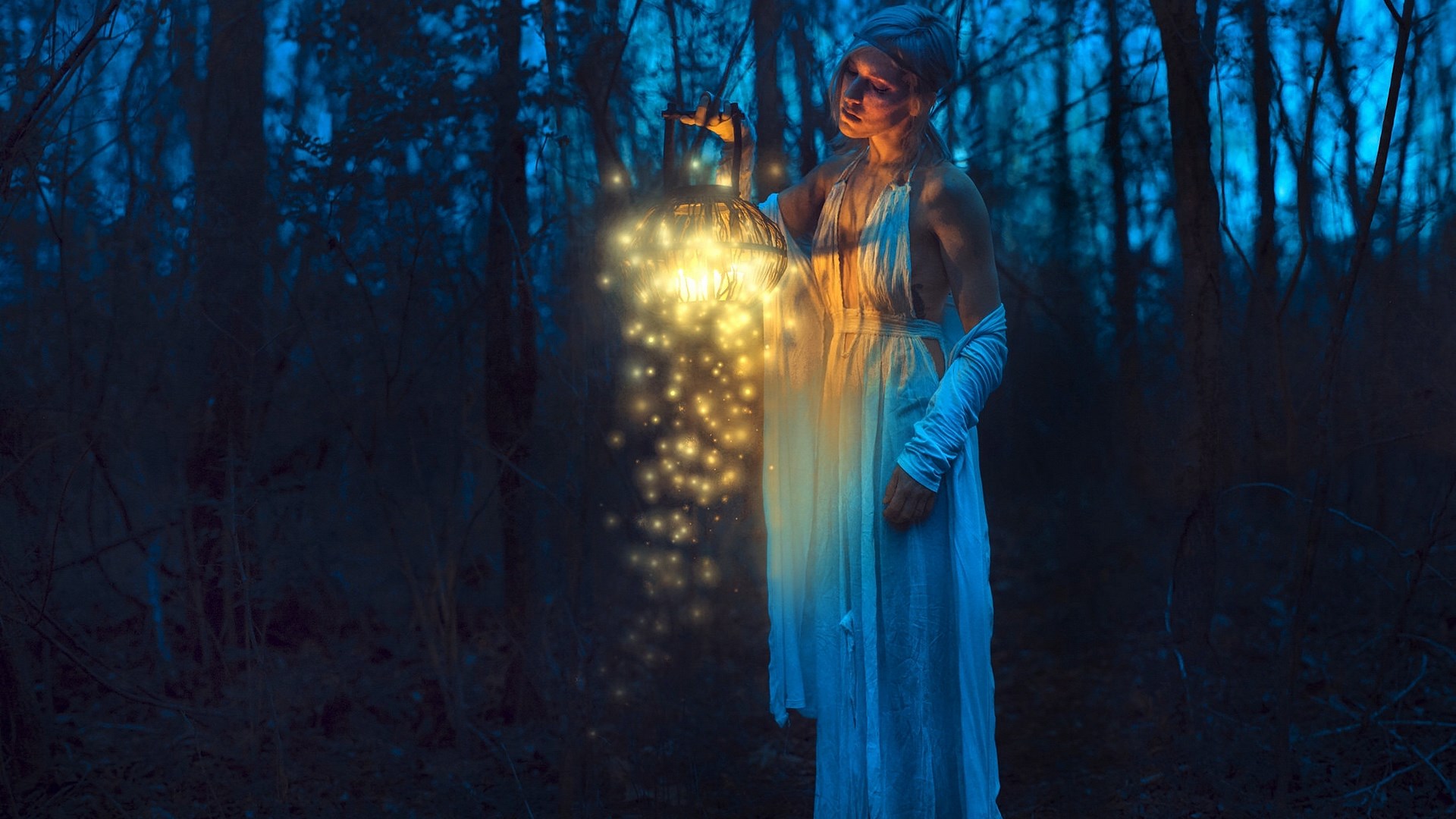 Woman holding a lantern in a dark forest HD Wallpaper