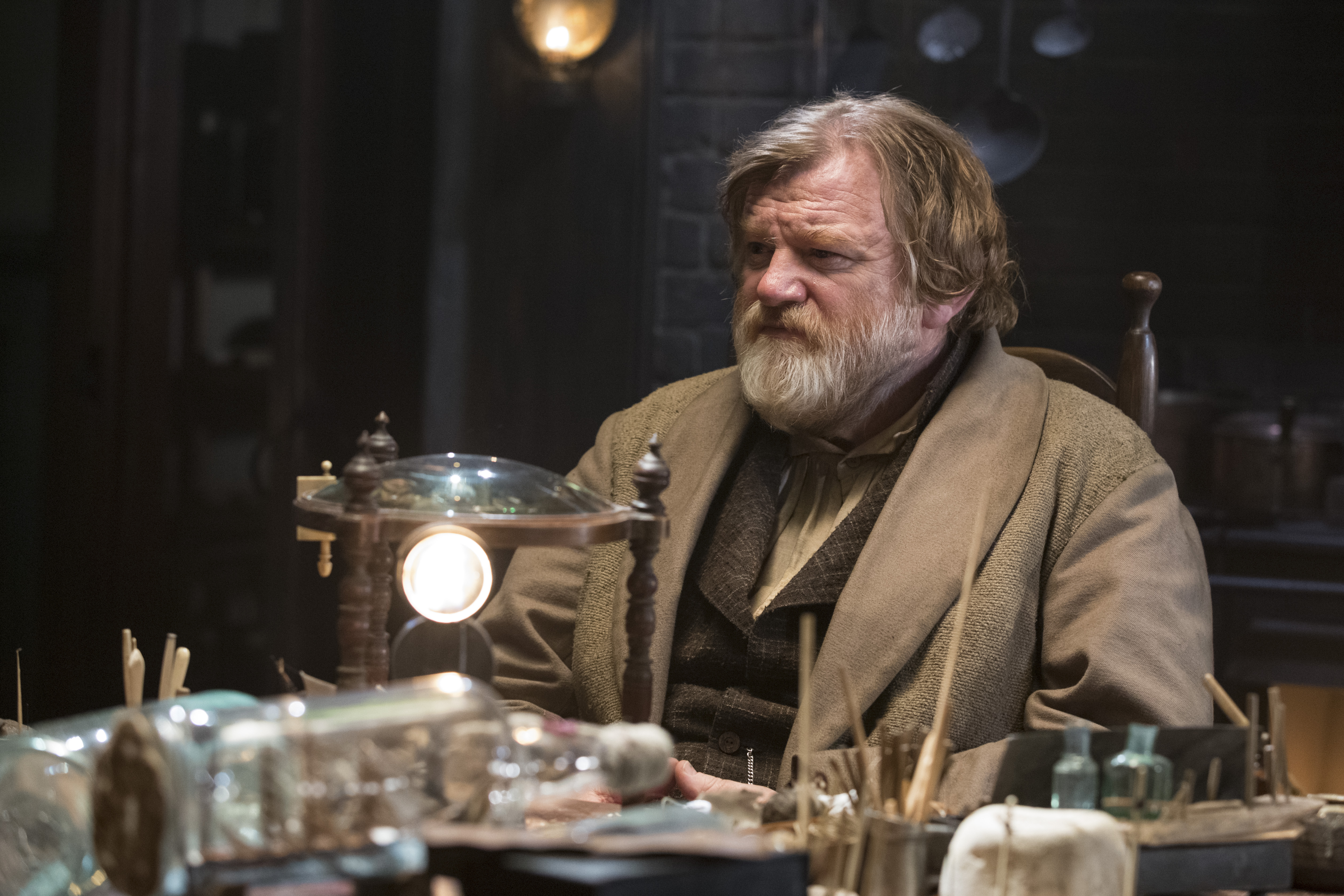 Brendan Gleeson in a dimly lit room HD Wallpaper