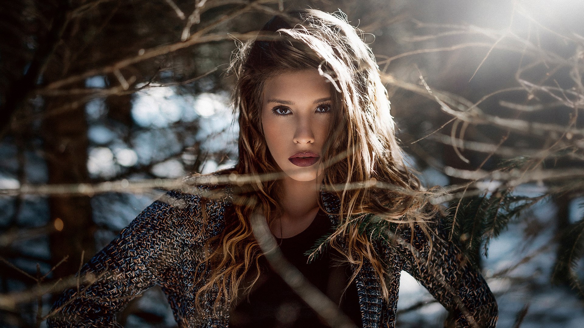 Woman in a patterned jacket in a forest HD Wallpaper
