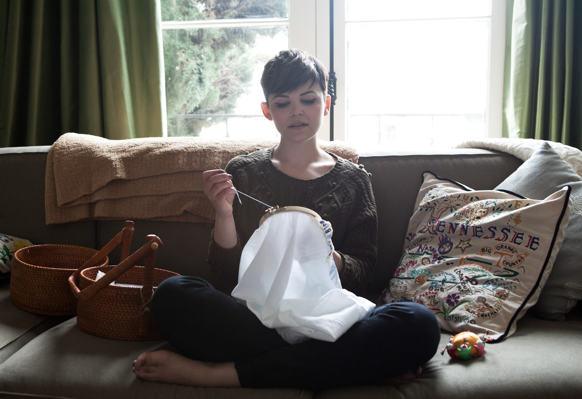 Ginnifer Goodwin embroidering on a couch HD Wallpaper