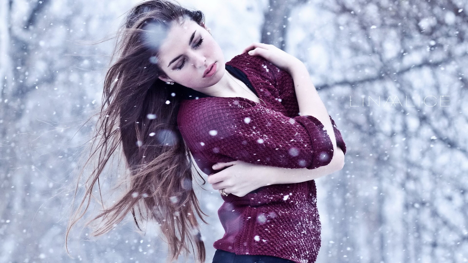 Woman in a maroon sweater in the snow HD Wallpaper