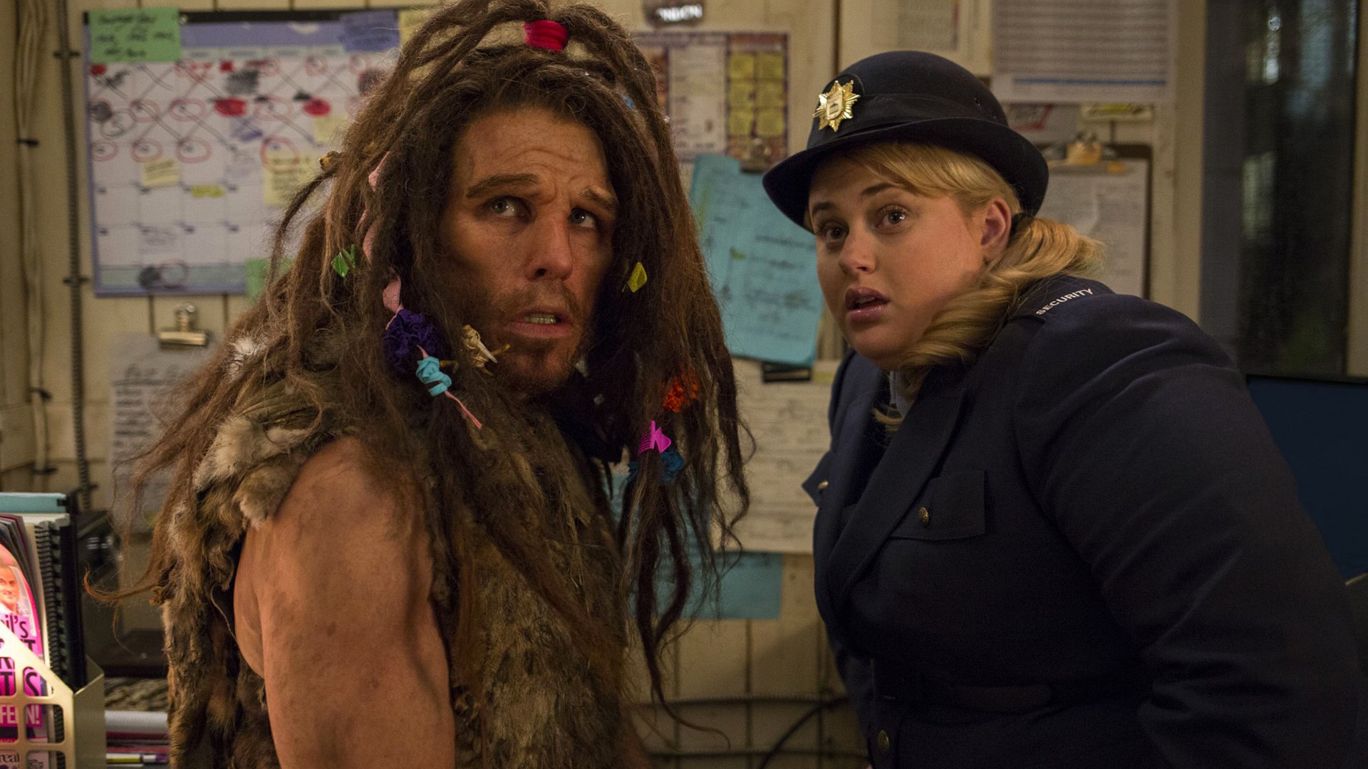 Man with dreadlocks and Rebel Wilson as security guard HD Wallpaper