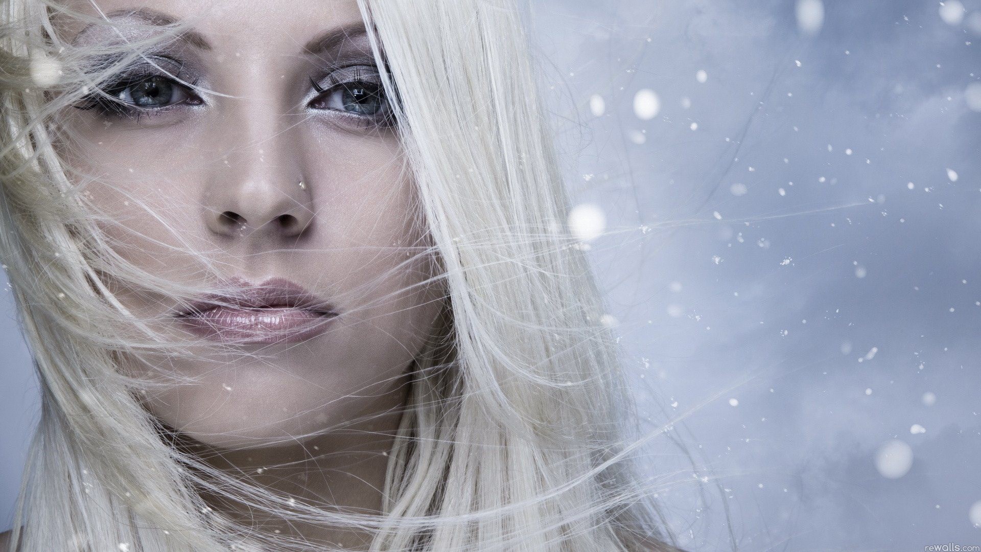 Woman with blonde hair in snow HD Wallpaper