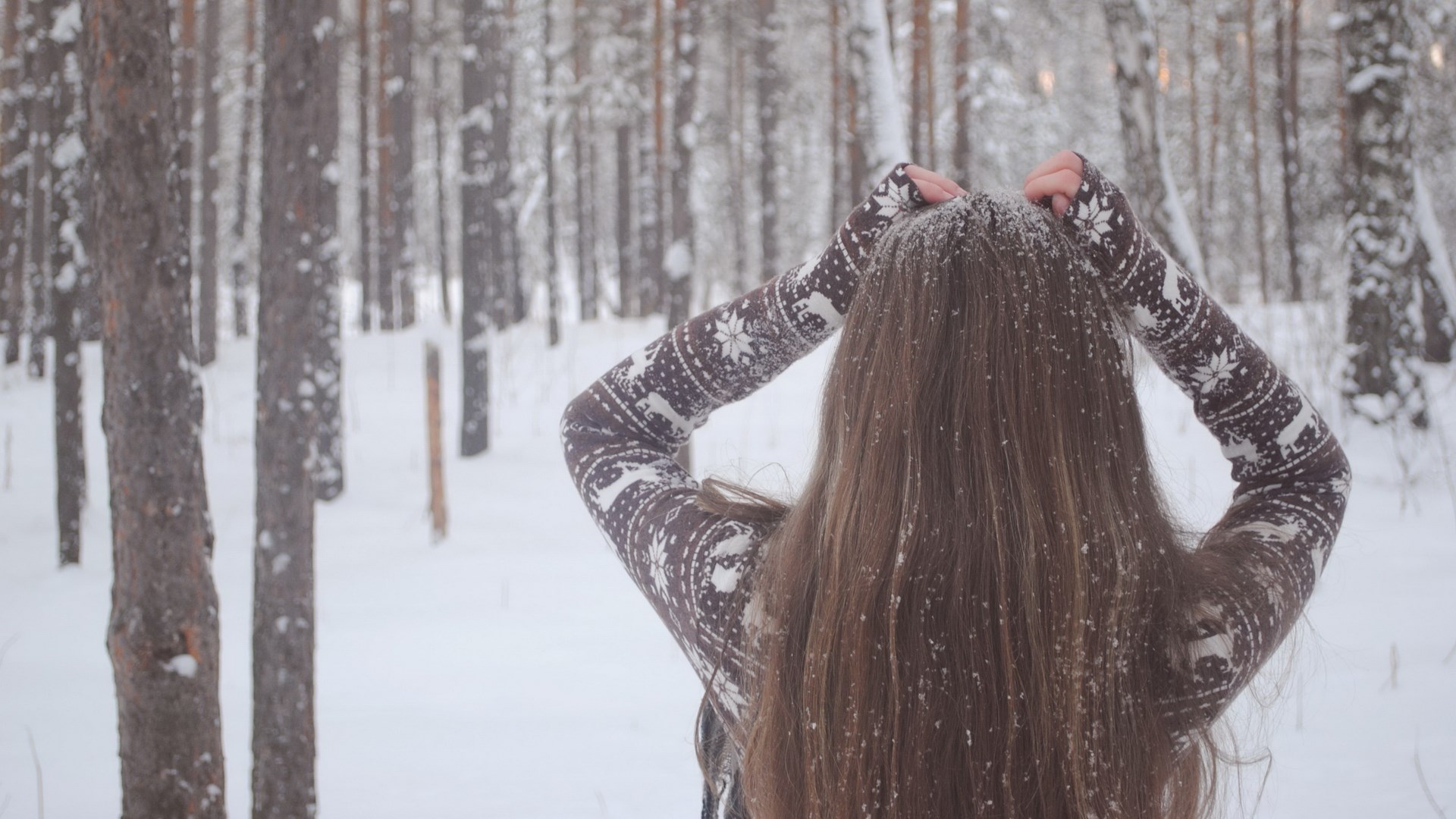 Woman in snowy forest with hands on head HD Wallpaper