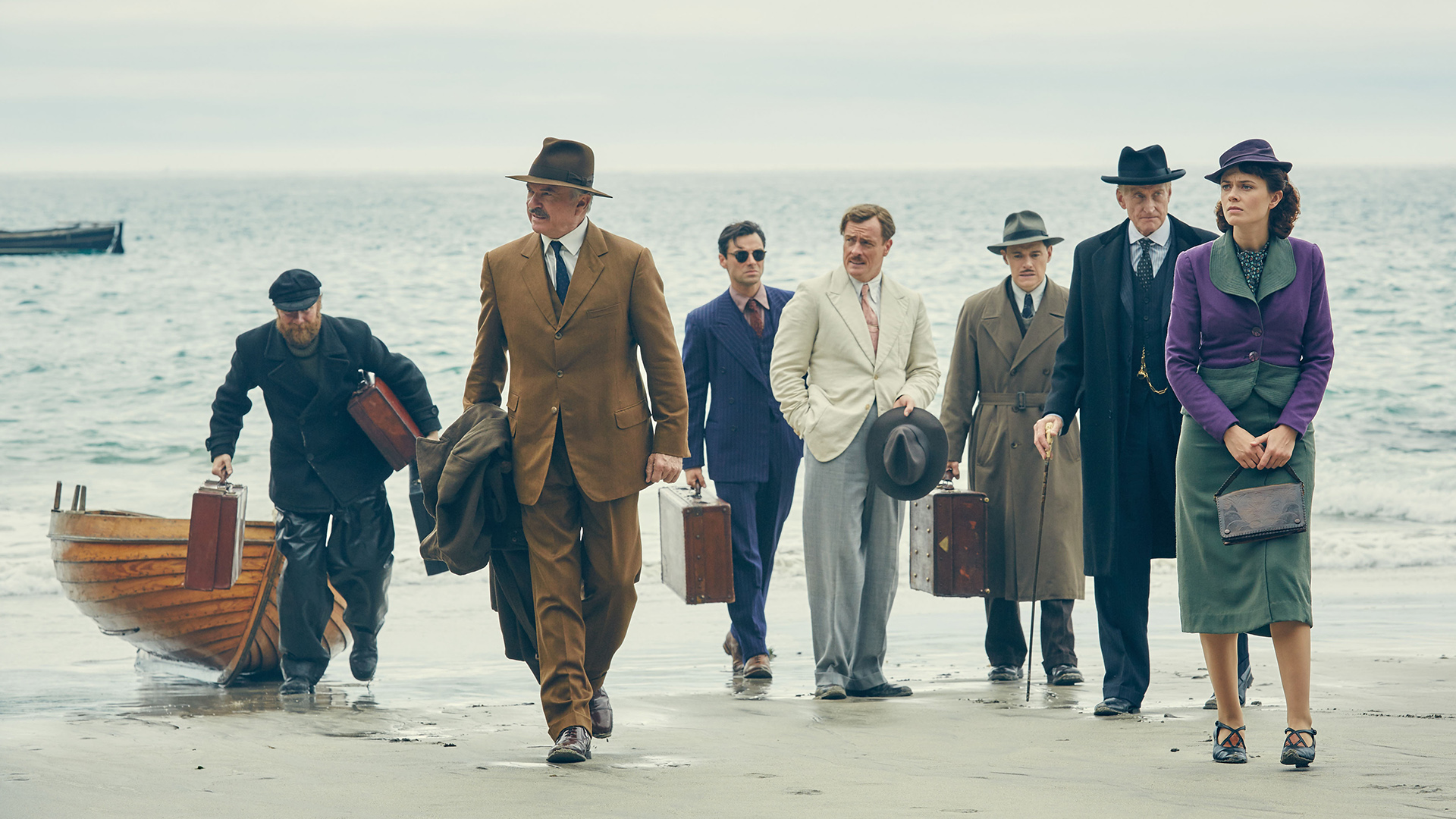 Sam Neill and group on a beach HD Wallpaper