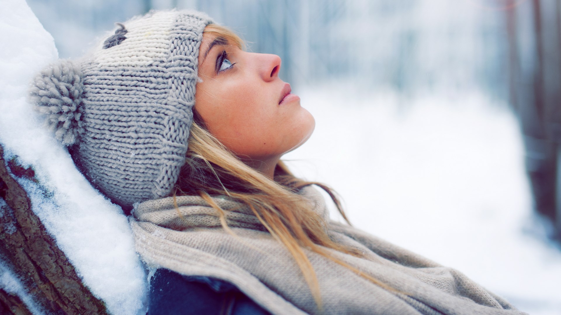 Woman in winter hat and scarf looking up HD Wallpaper