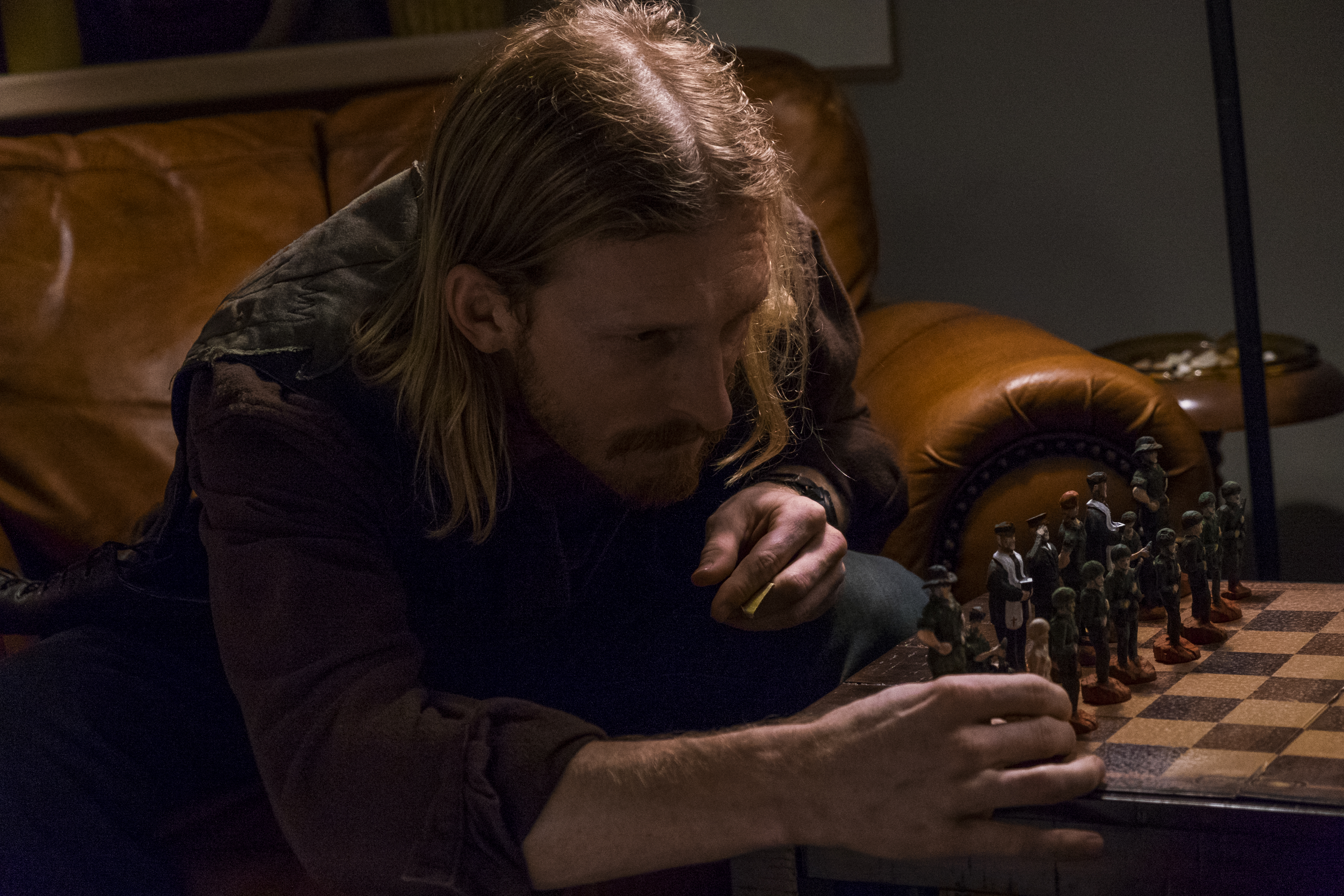 Austin Amelio playing chess with figurines HD Wallpaper