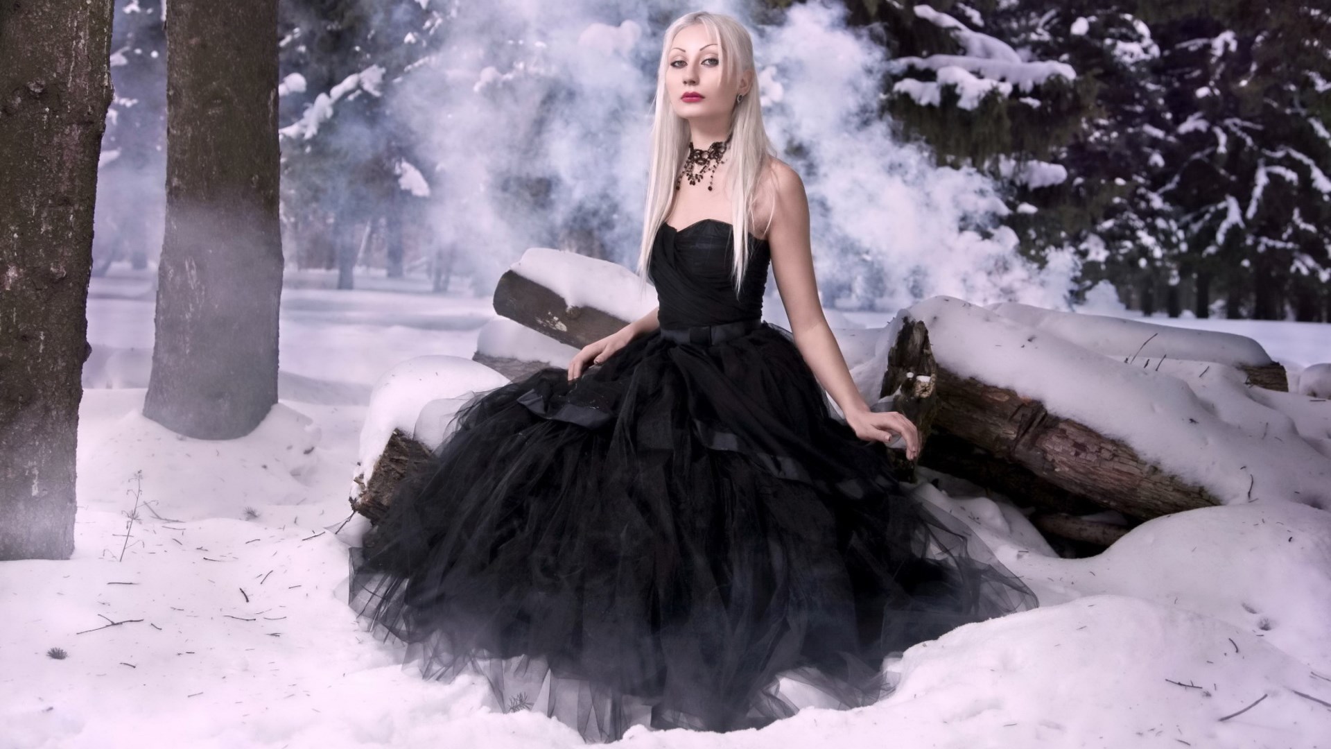 Woman in black dress in snowy forest HD Wallpaper