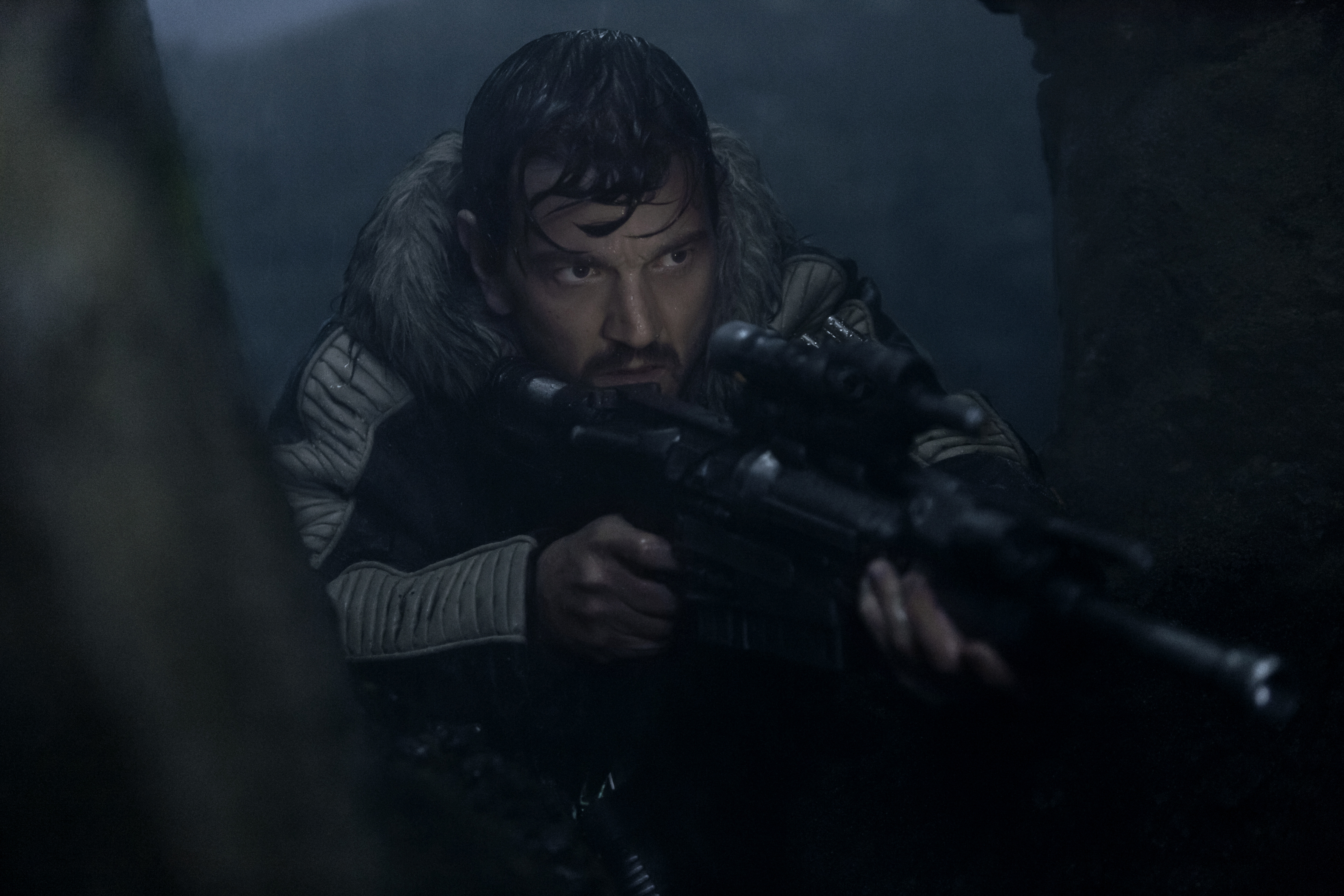 Diego Luna as Cassian Andor with a blaster rifle HD Wallpaper