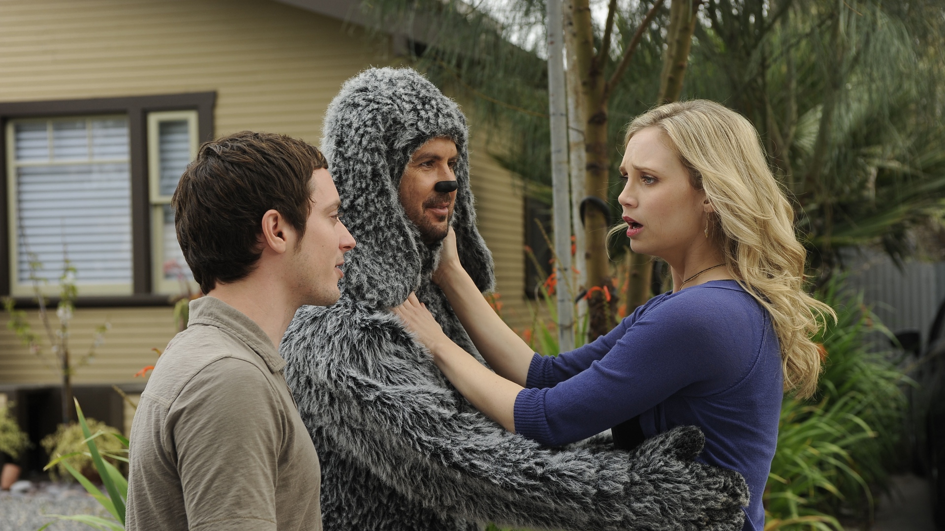 Jason Gann in a dog costume with two people HD Wallpaper