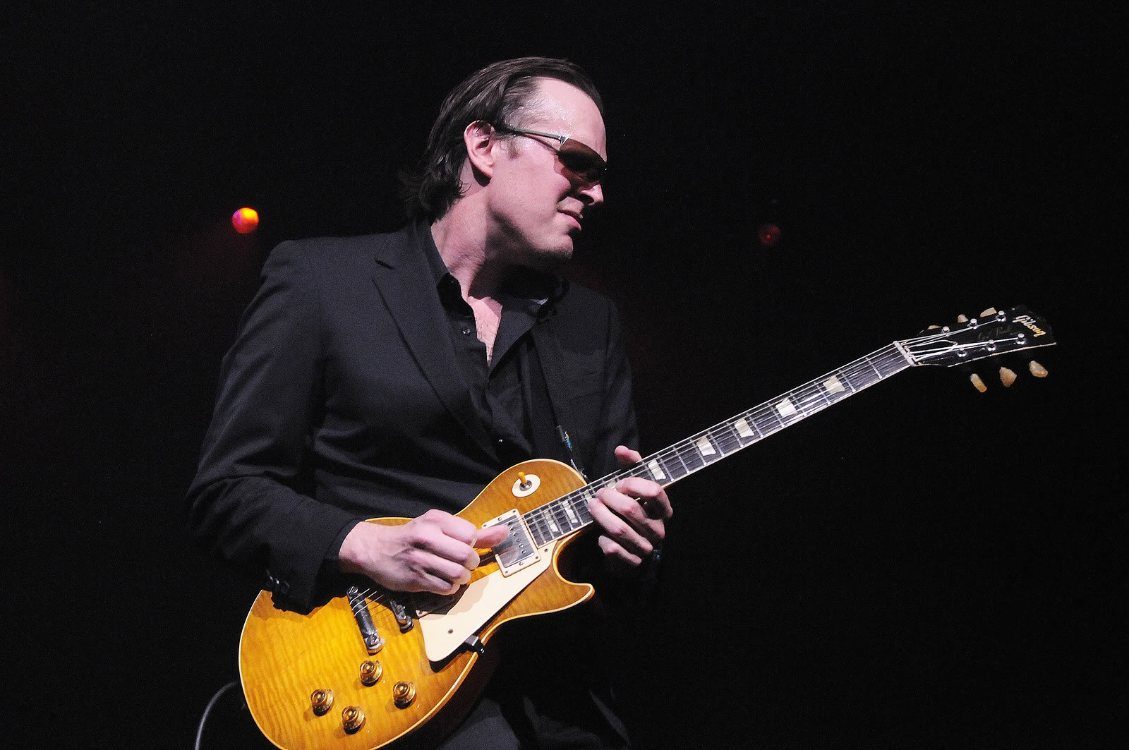 Joe Bonamassa playing a guitar on stage HD Wallpaper