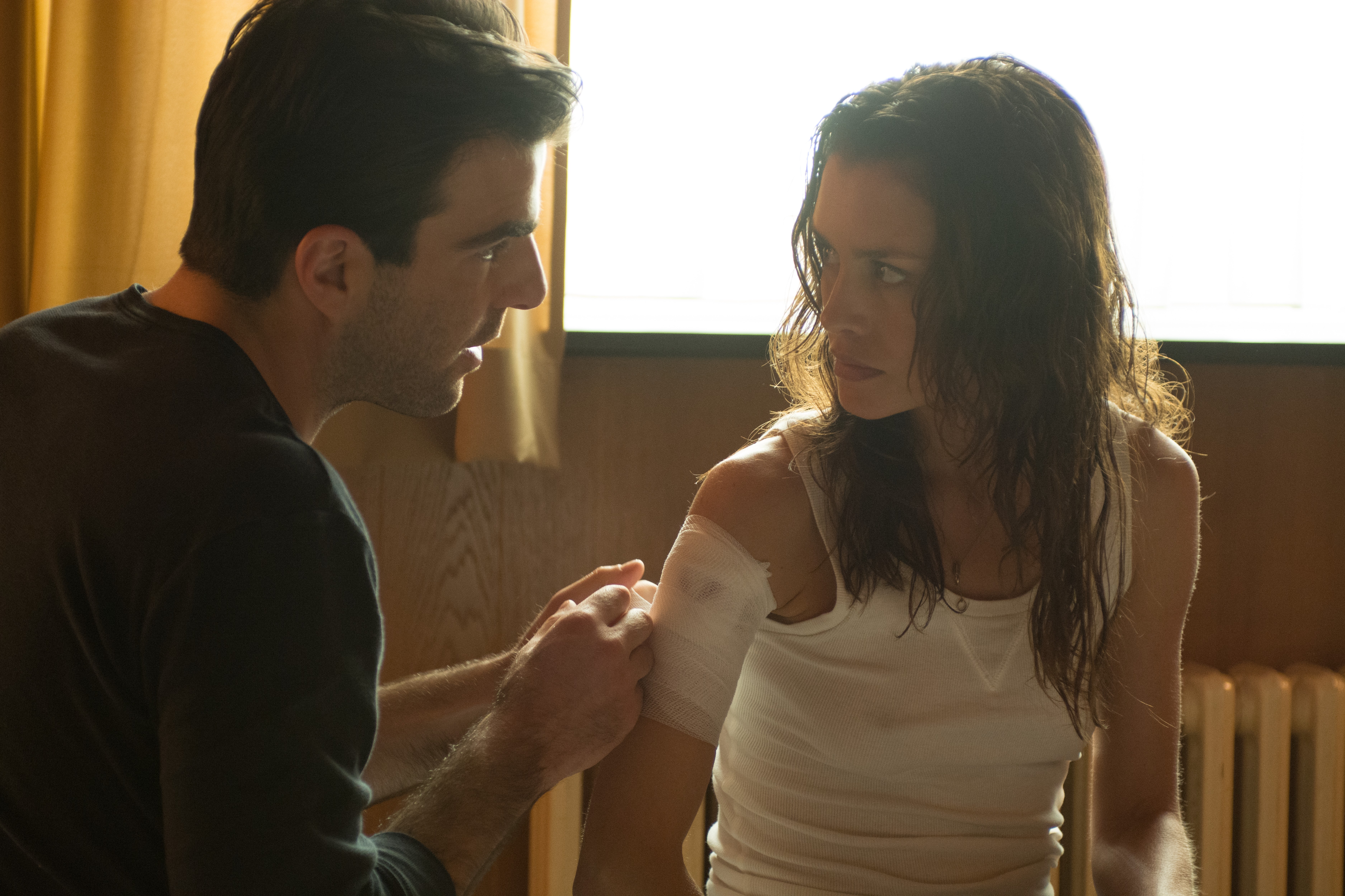 Man bandaging woman's arm HD Wallpaper
