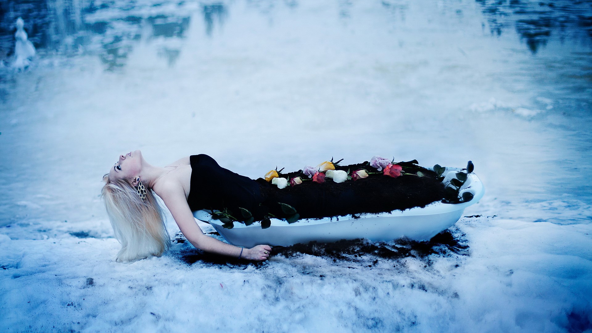 Woman lying in a bathtub filled with soil and flowers HD Wallpaper