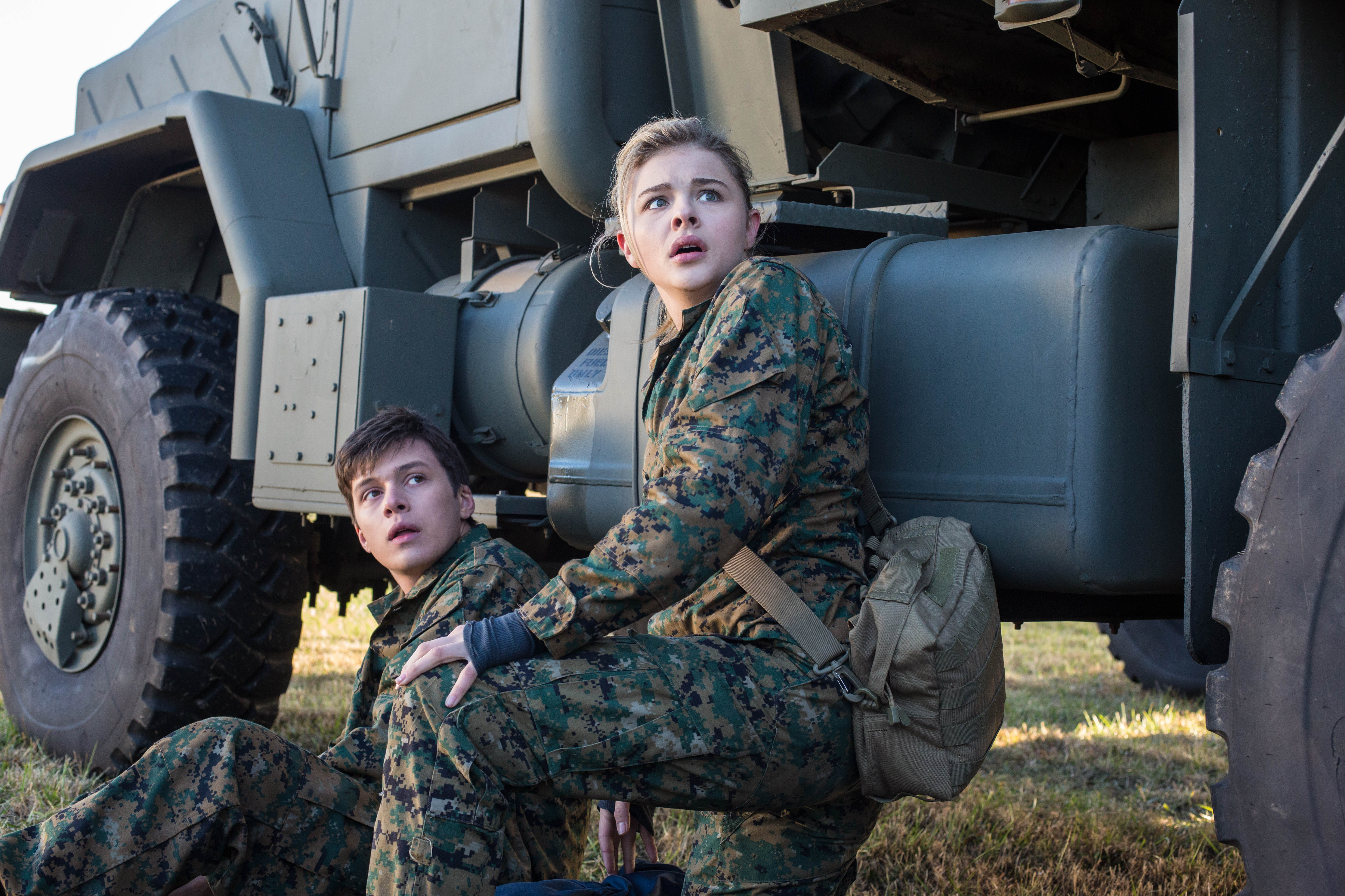 Nick Robinson and Chloe Grace Moretz in military uniforms HD Wallpaper