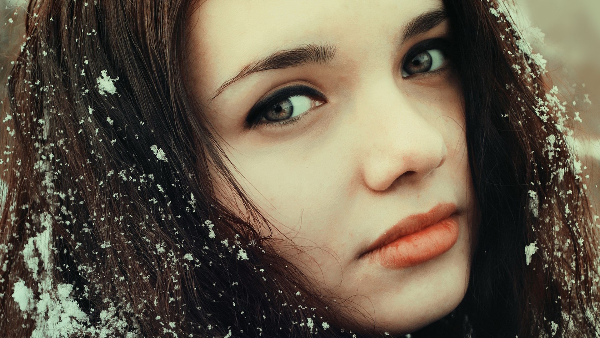 Close-up of a young woman with snow in her hair HD Wallpaper