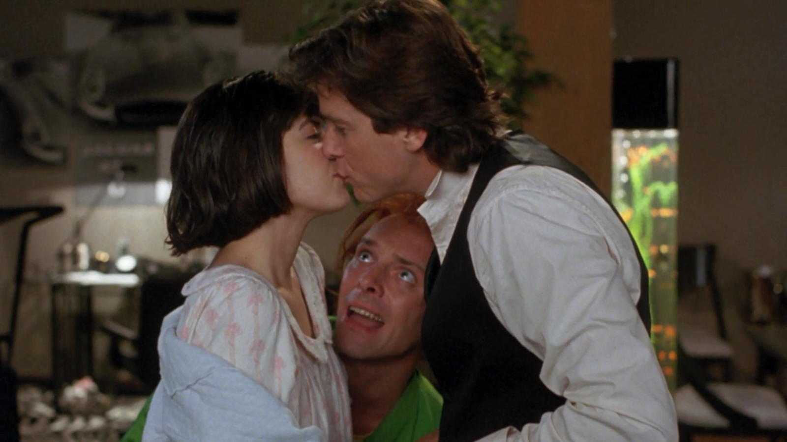 Phoebe Cates kissing a man while another man looks on HD Wallpaper