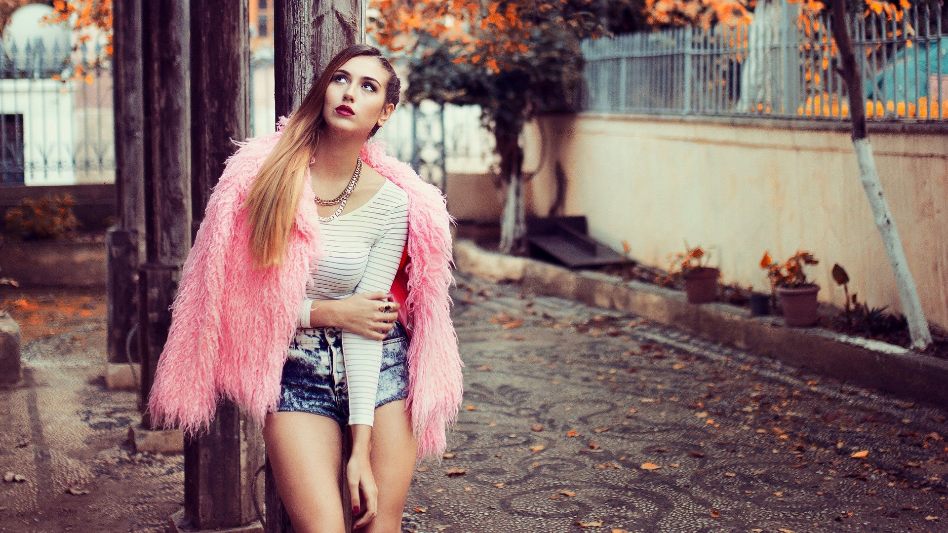 Woman in pink fur coat and denim shorts HD Wallpaper